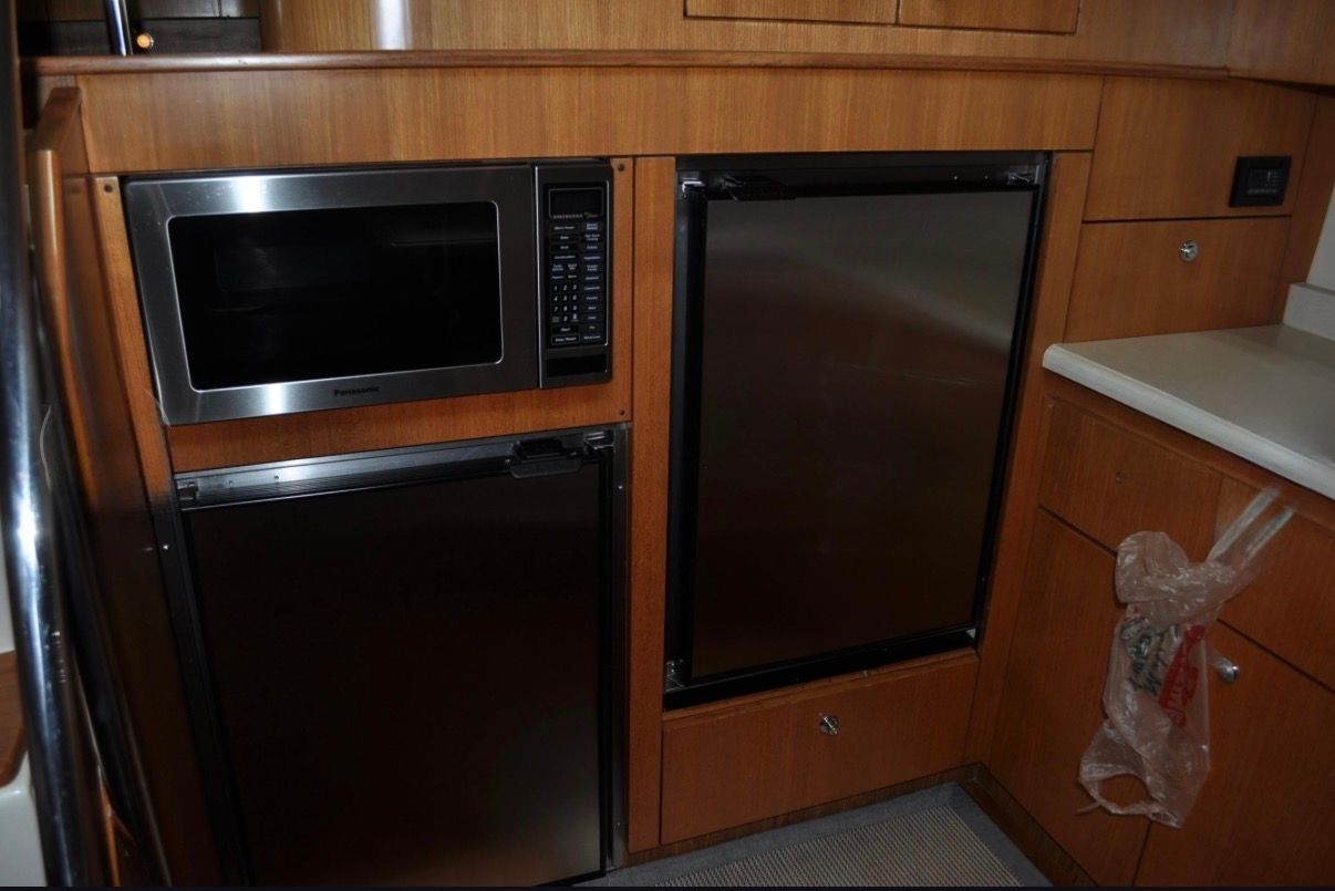 The 2005 Tiara Yachts 5200 Sovran's galley features a microwave and a refrigerator.