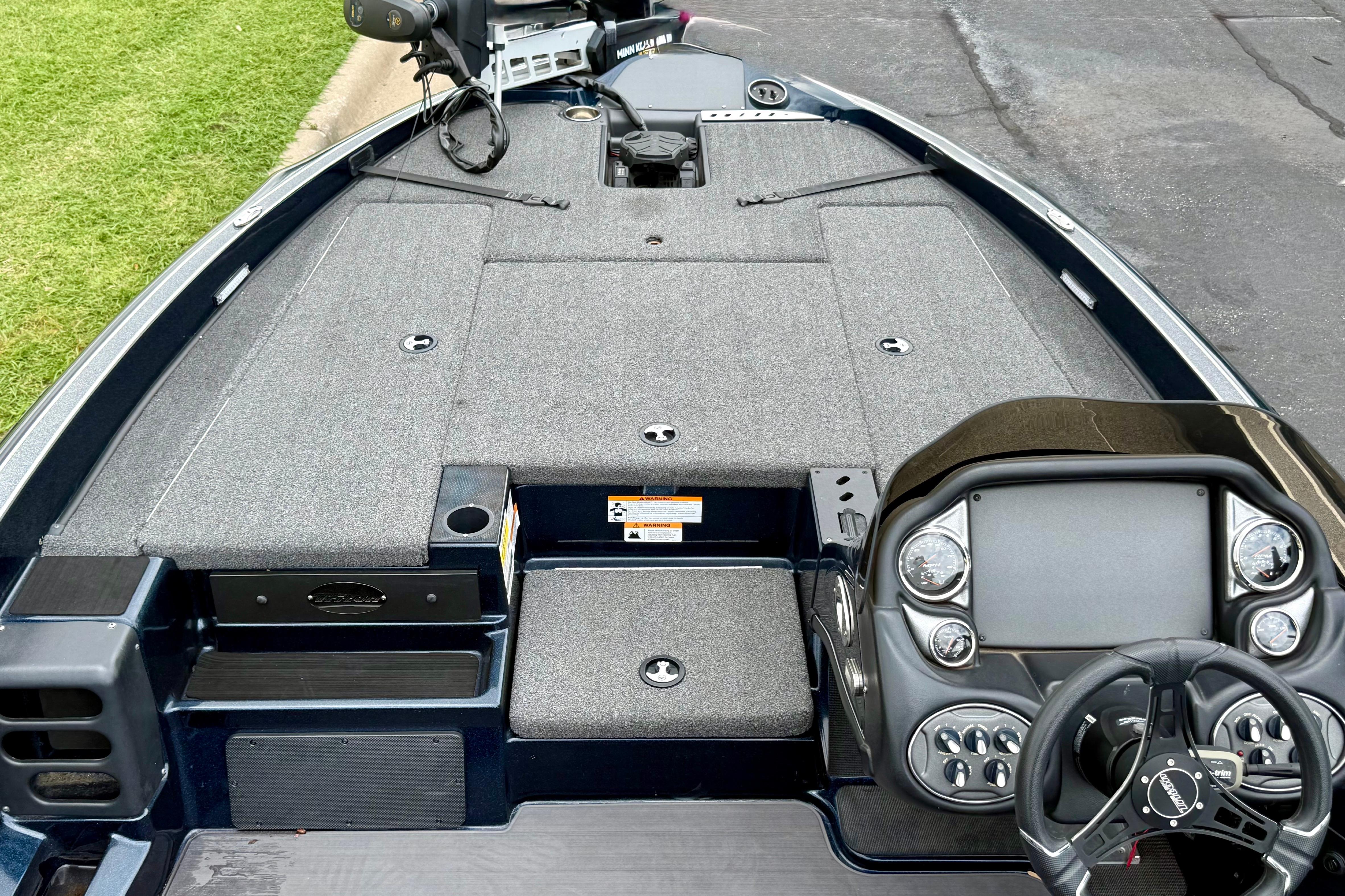 2023 Triton 18 TrX boat interior with steering console and spacious deck layout.
