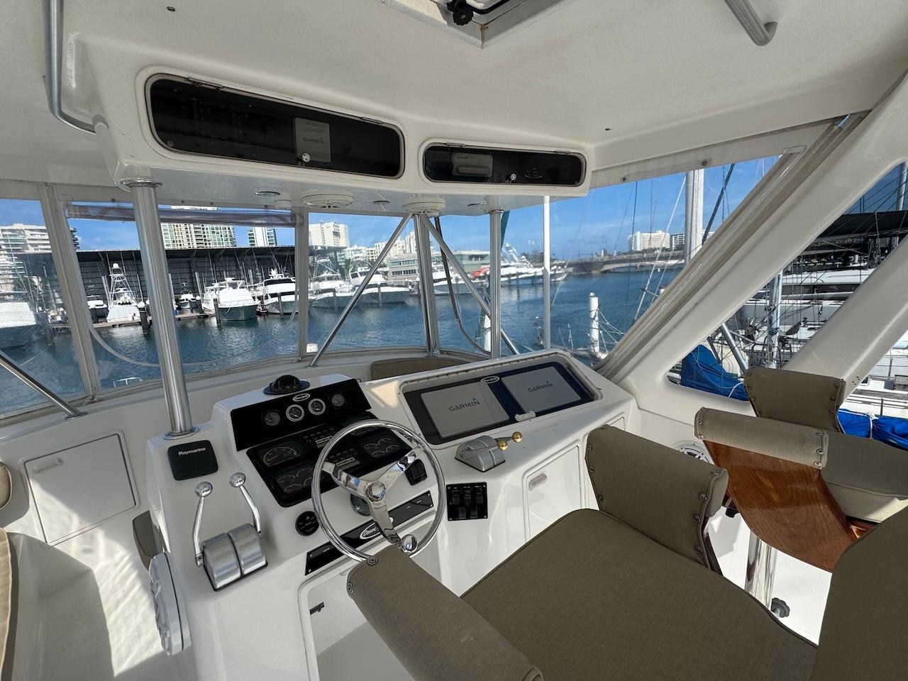 Helm of 2000 Ocean Yachts 48 Convertible with marina view.