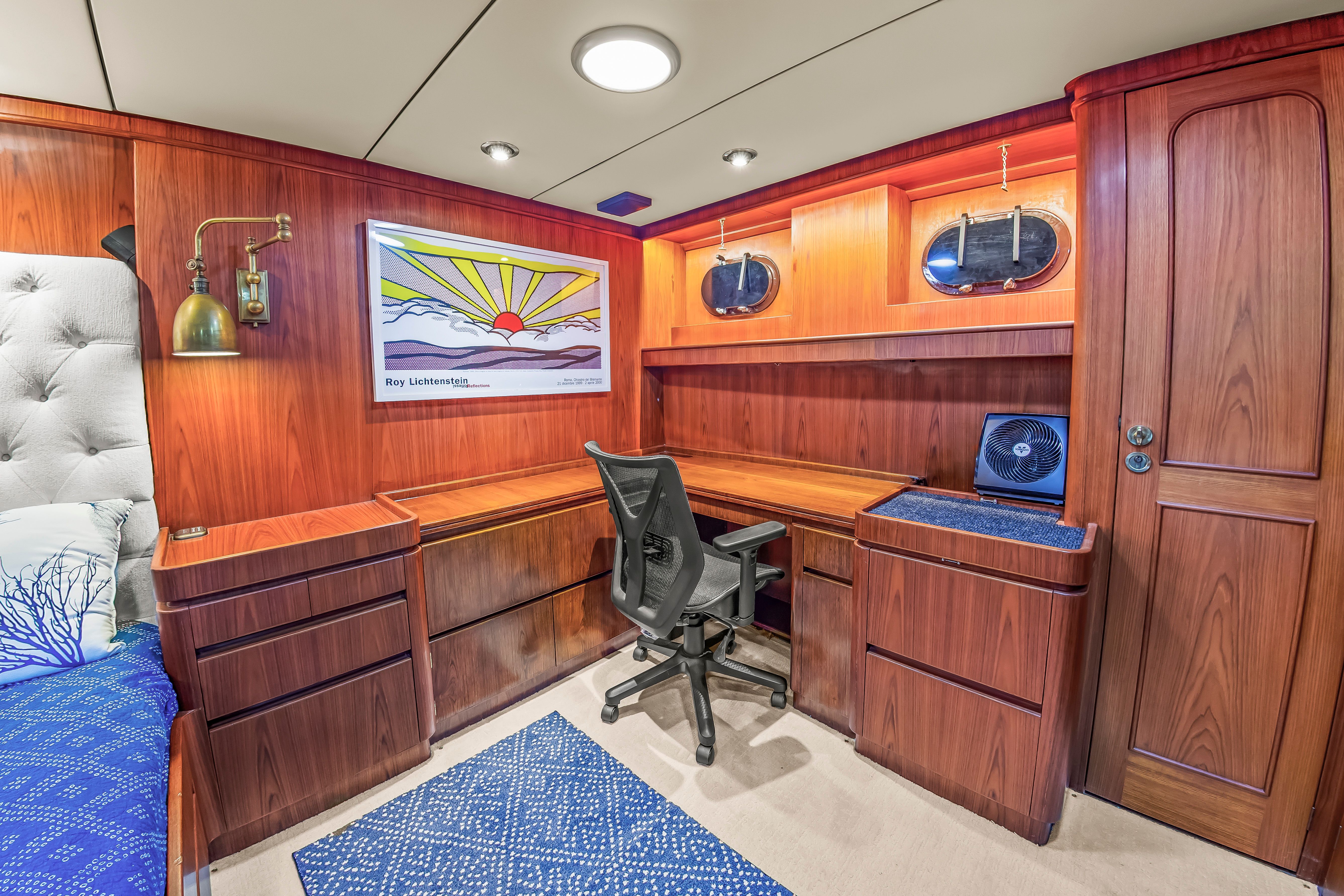 Interior of a 1987 Jongert 78 Motor Yacht with wooden furnishings and a desk.