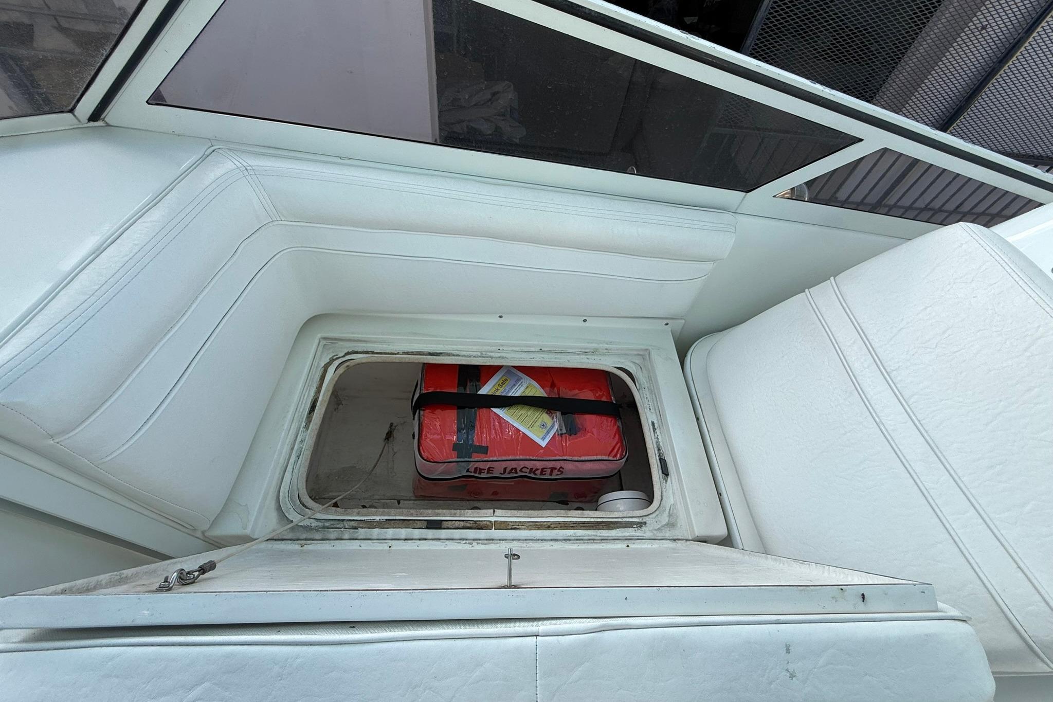 1998 Contender 35 Express boat interior with life jackets in storage compartment.