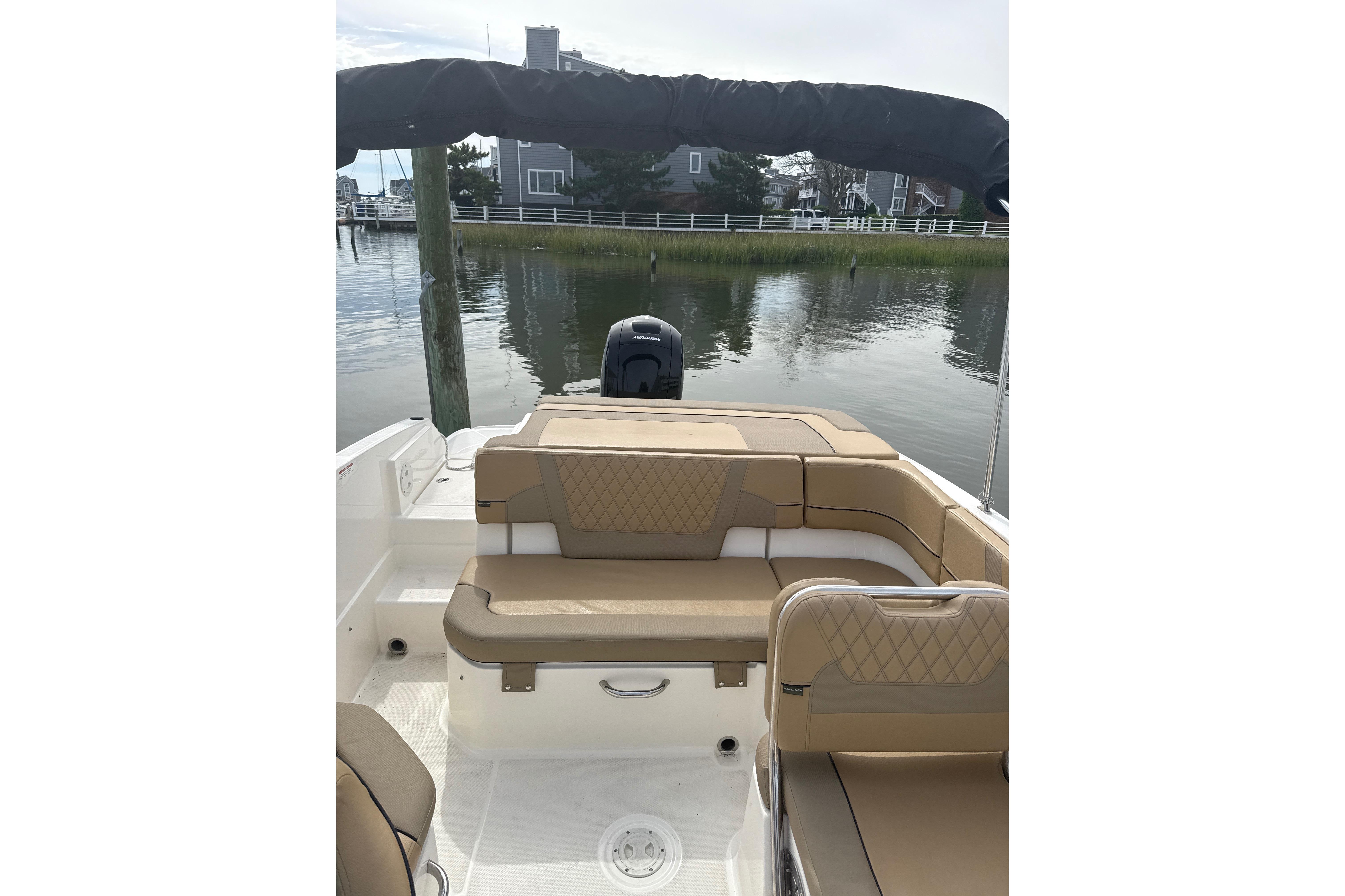2025 Bayliner VR6 Bowrider OB with tan seating, docked by calm waters.