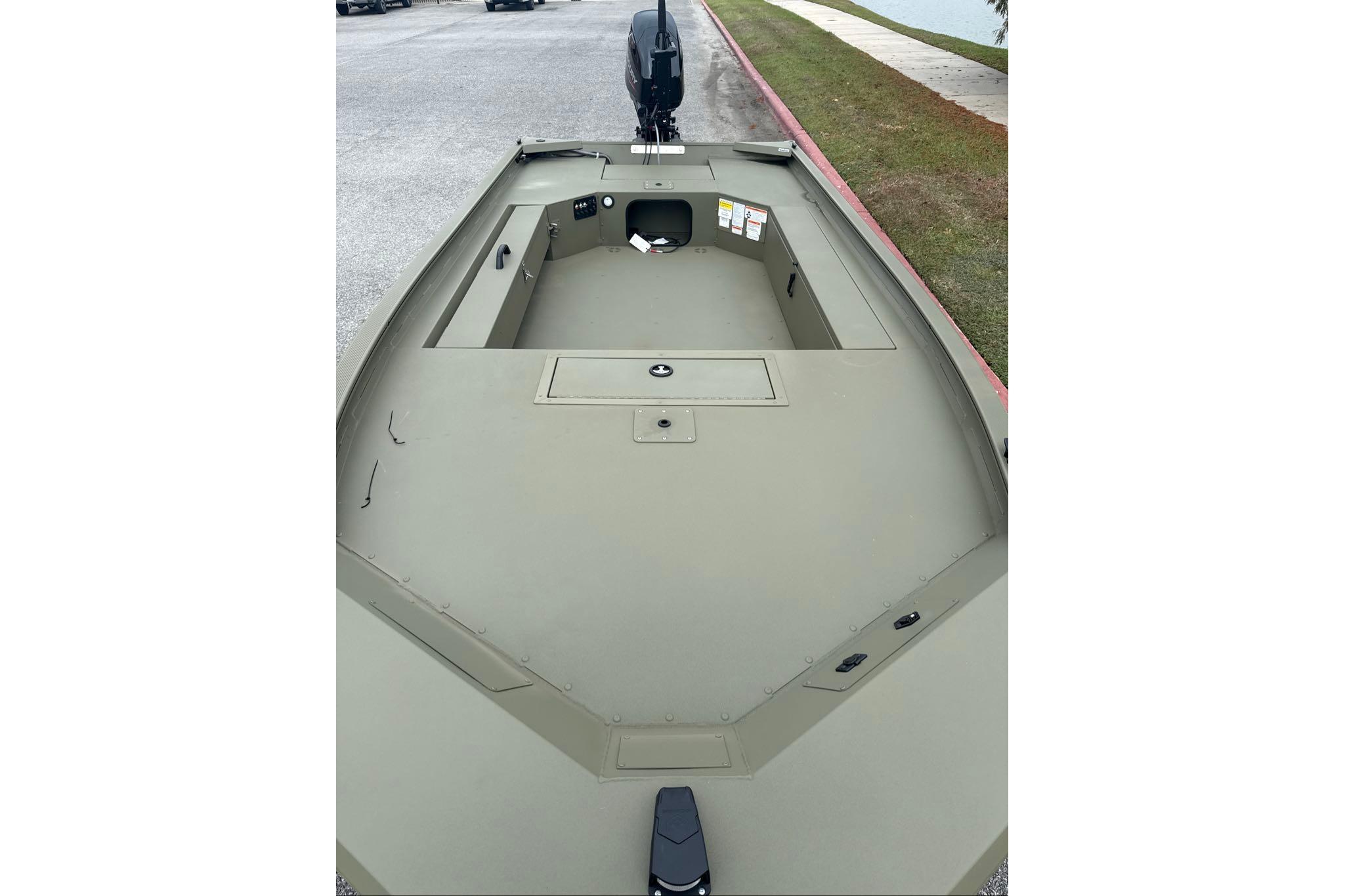 2026 Tracker Grizzly 1654 T Sportsman boat interior, showcasing spacious deck and storage compartments.