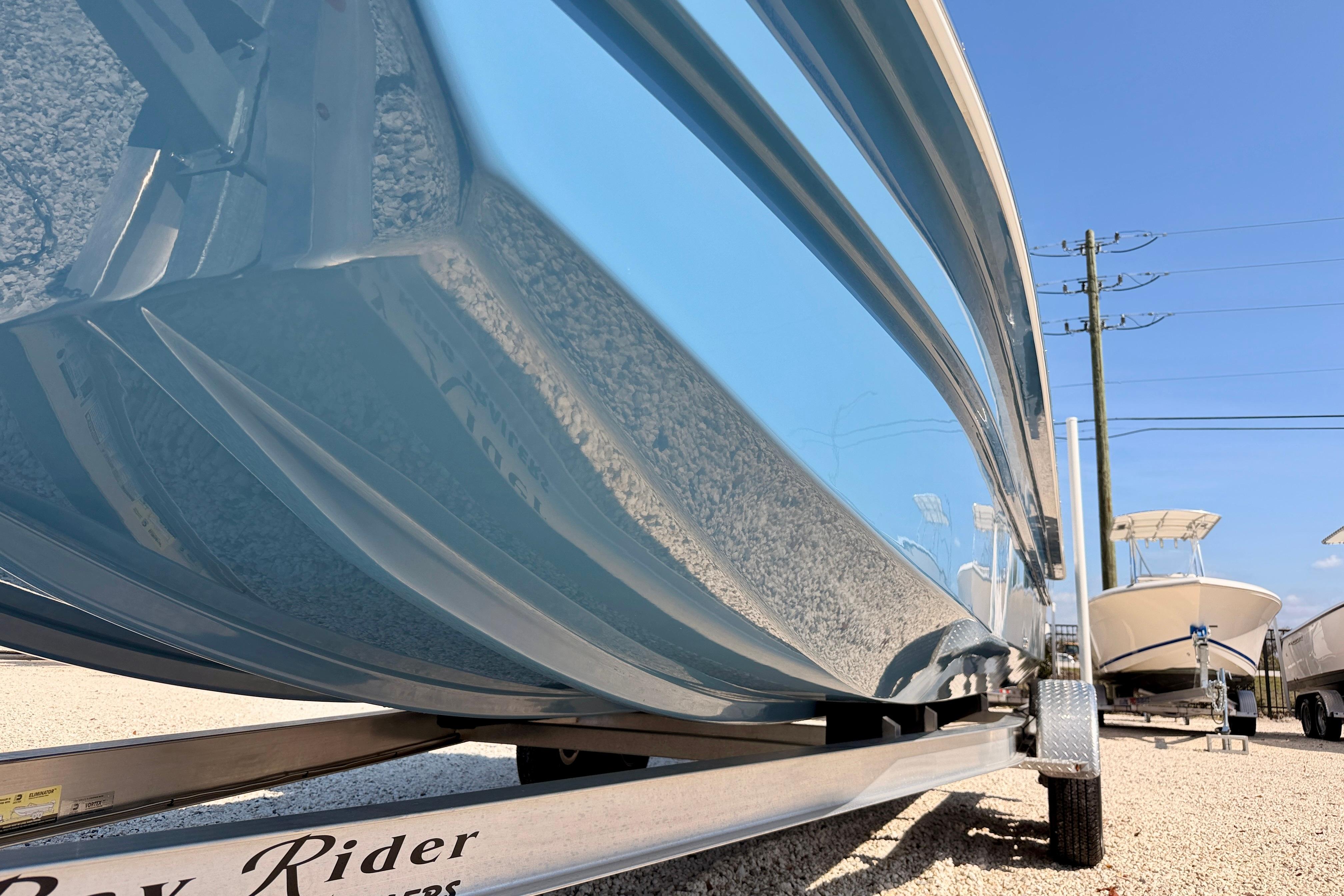 2026 Bay Rider 2460 FS Skiff on trailer, showcasing sleek hull design.