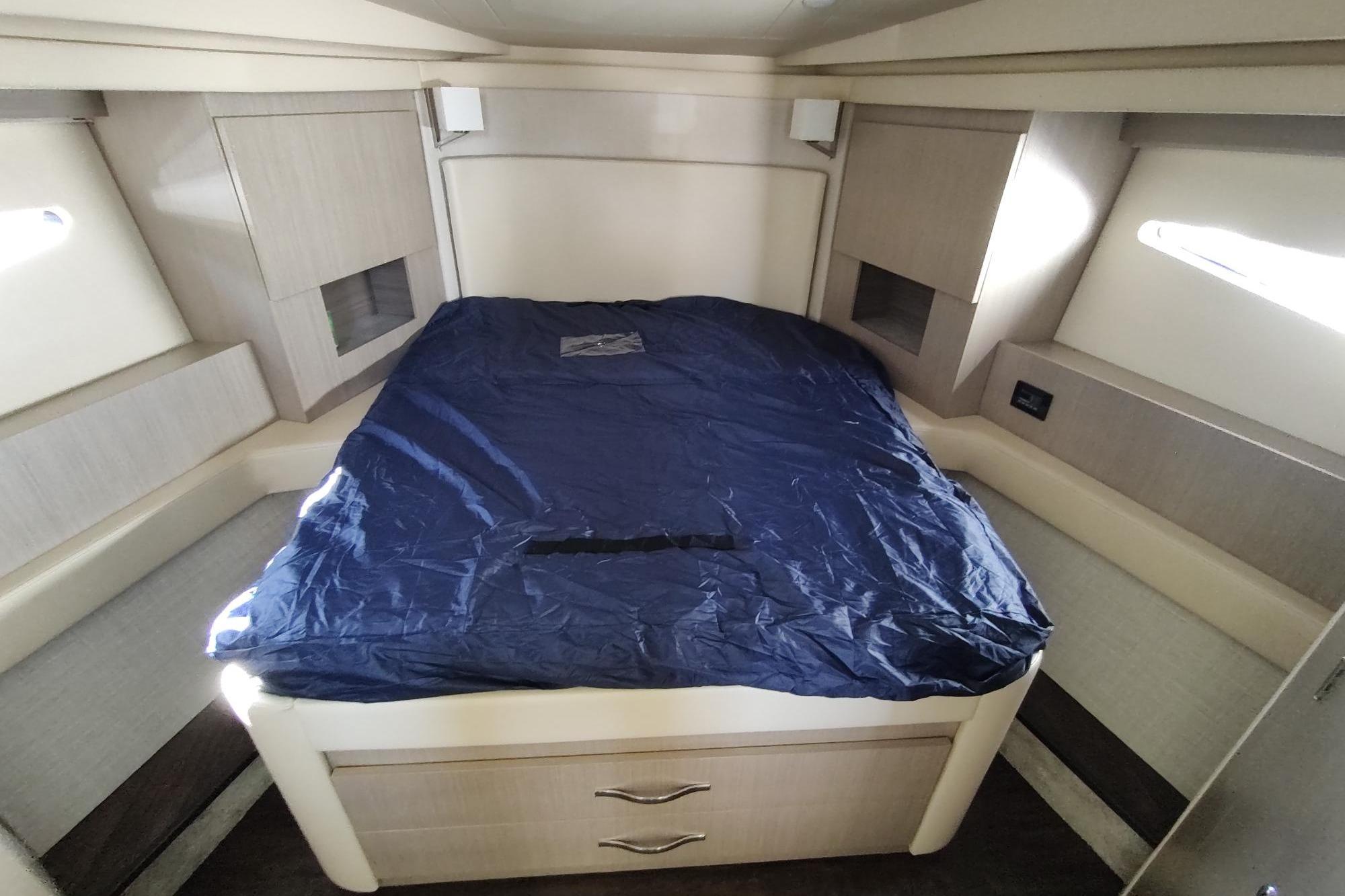 Luxurious cabin interior of 2021 Regal 42 Fly yacht with a neatly made bed.