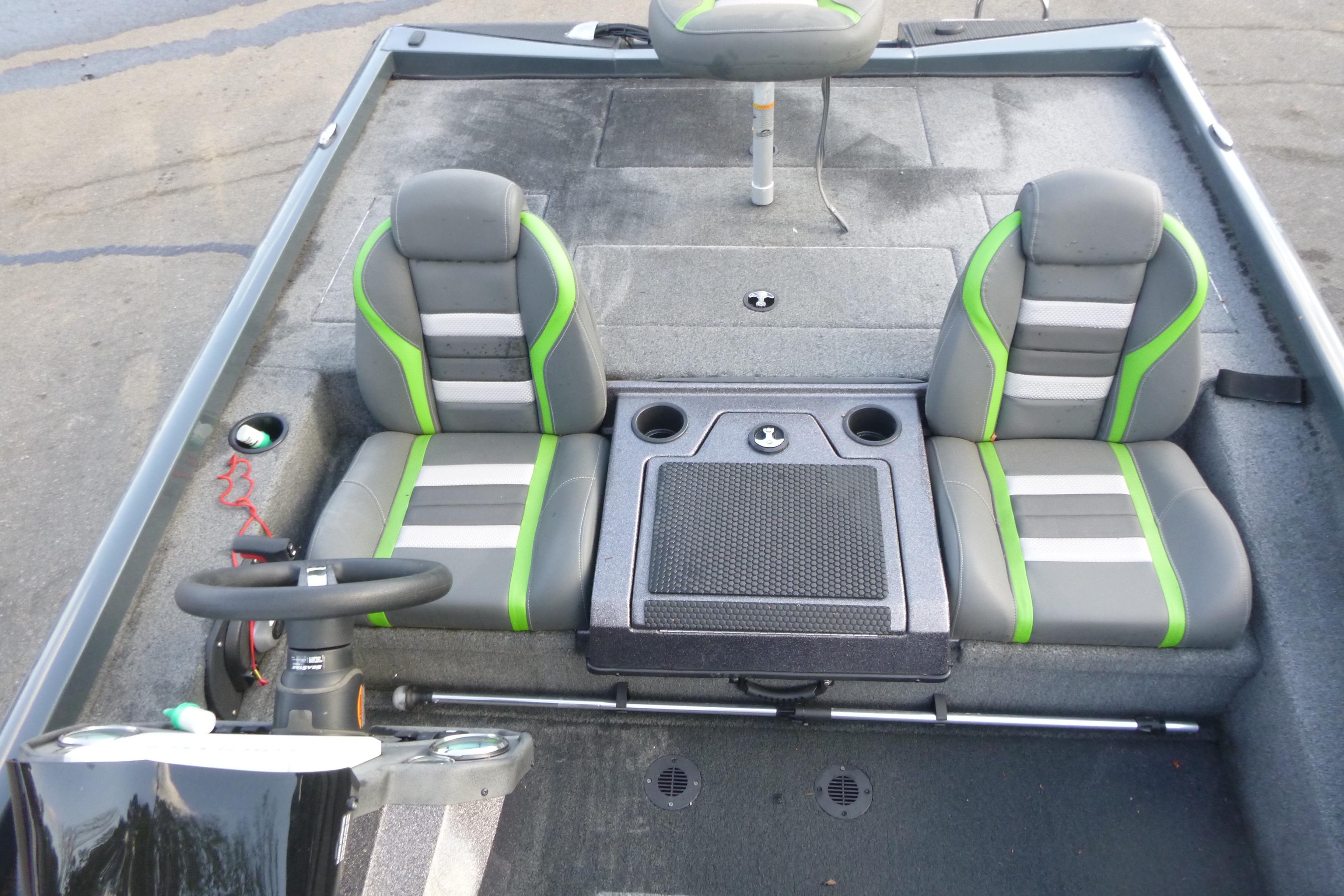 2023 Ranger RT198P boat interior with gray and green seats, steering wheel, and storage console.