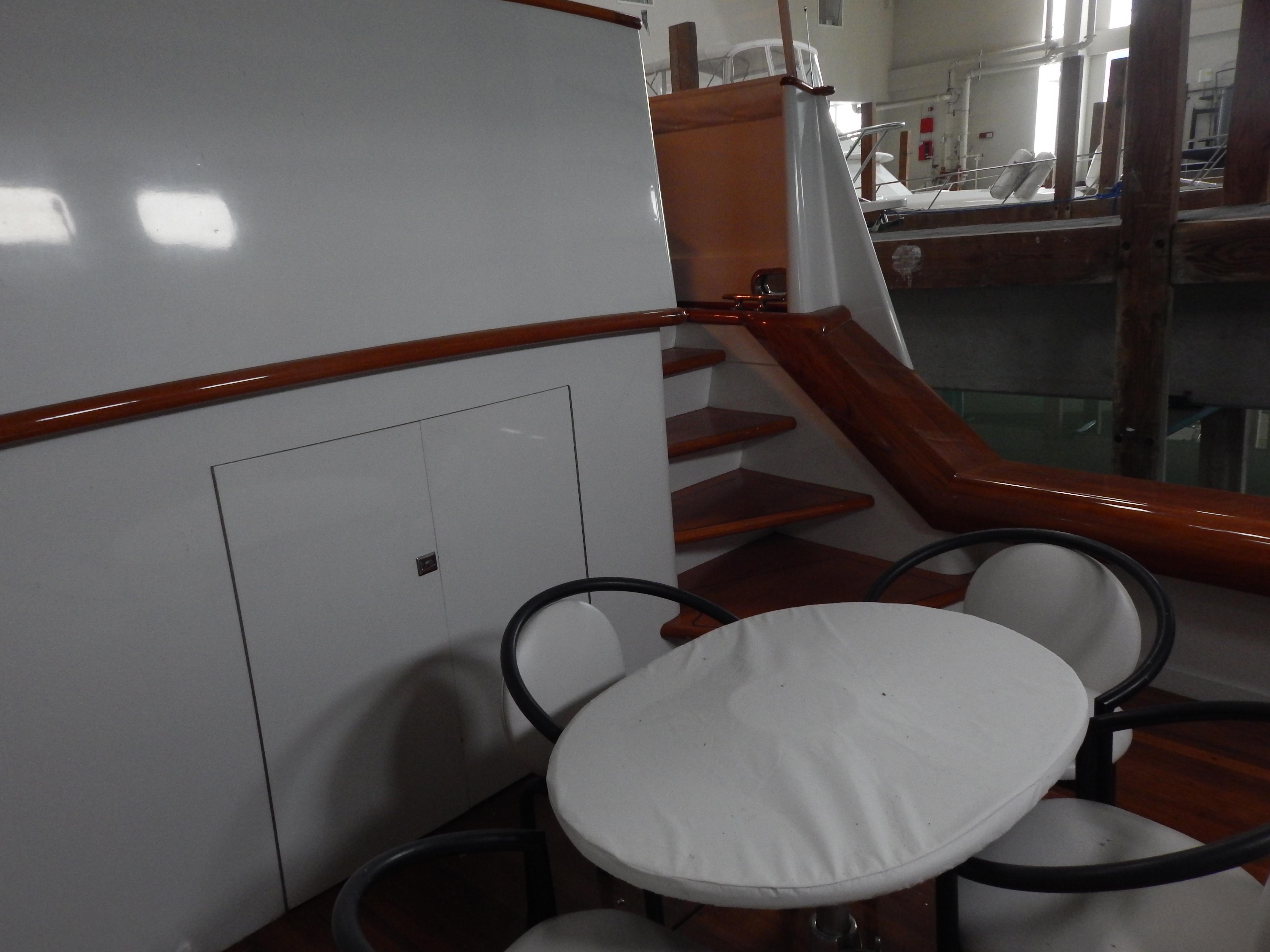 1974 Pacemaker Cockpit Motoryacht interior with stairs and round table seating.