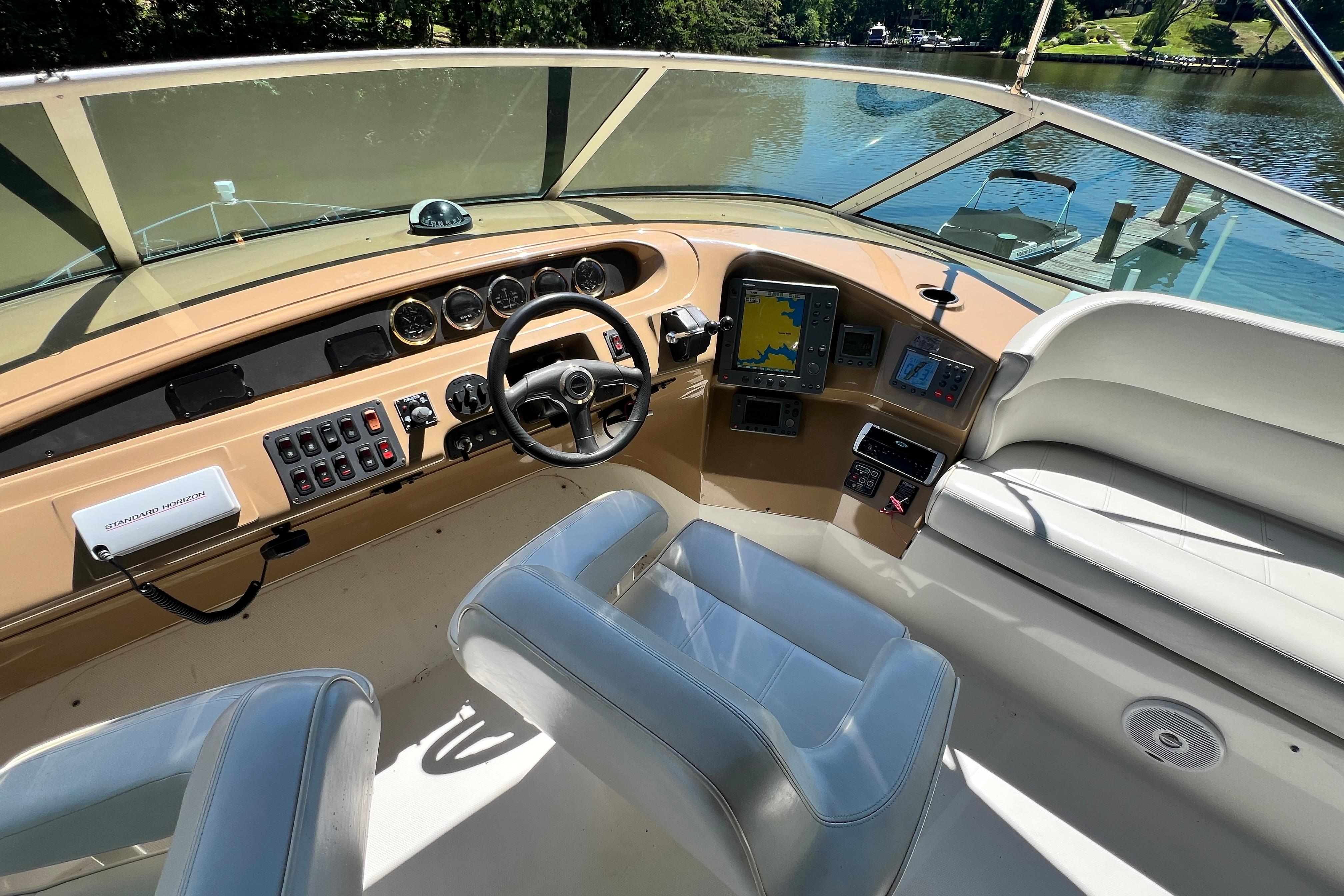 2003 Carver 450 Voyager Pilothouse helm with navigation instruments and comfortable seating.