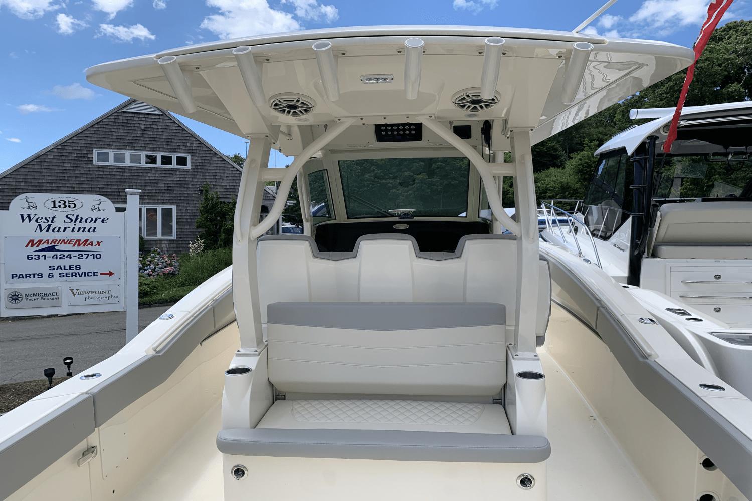 2024 Scout 357LXF boat at West Shore Marina, showcasing seating and helm area.