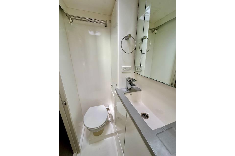 Compact bathroom in a 2017 Leopard 40 yacht, featuring modern fixtures and a sleek design.