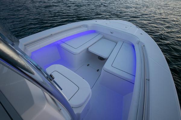 Manufacturer Provided Image: 2025 Southport 27 FE boat interior with blue LED lighting on calm water.