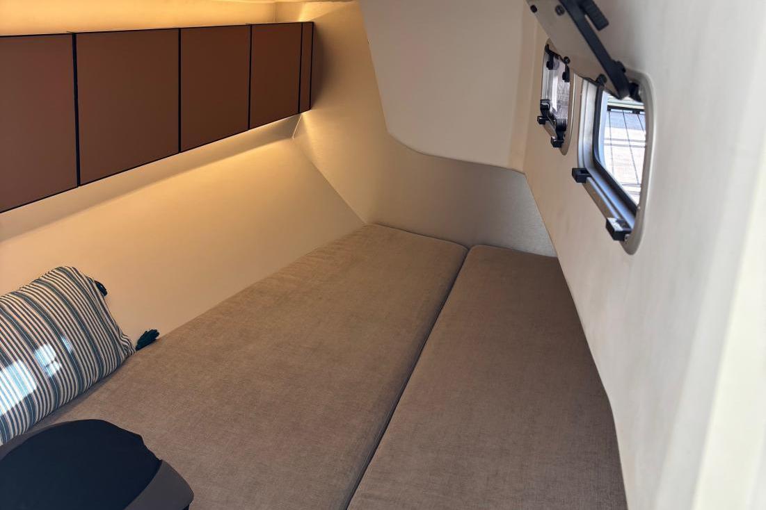 Cozy interior cabin of 2022 Italia Yachts 11.98 with comfortable bedding and storage.