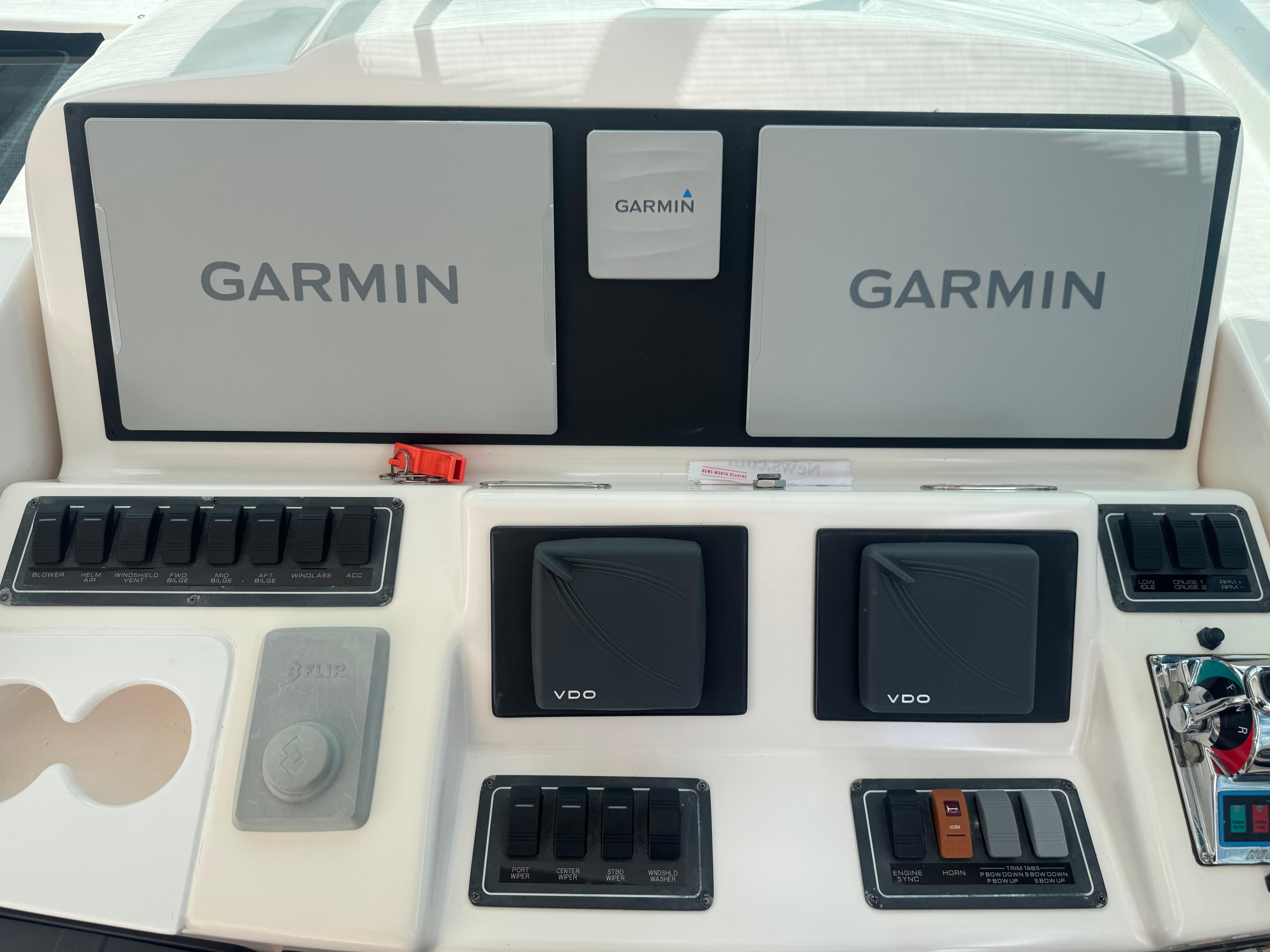 Control panel of a 2006 Tiara Yachts 4200 Open with Garmin displays and switches.