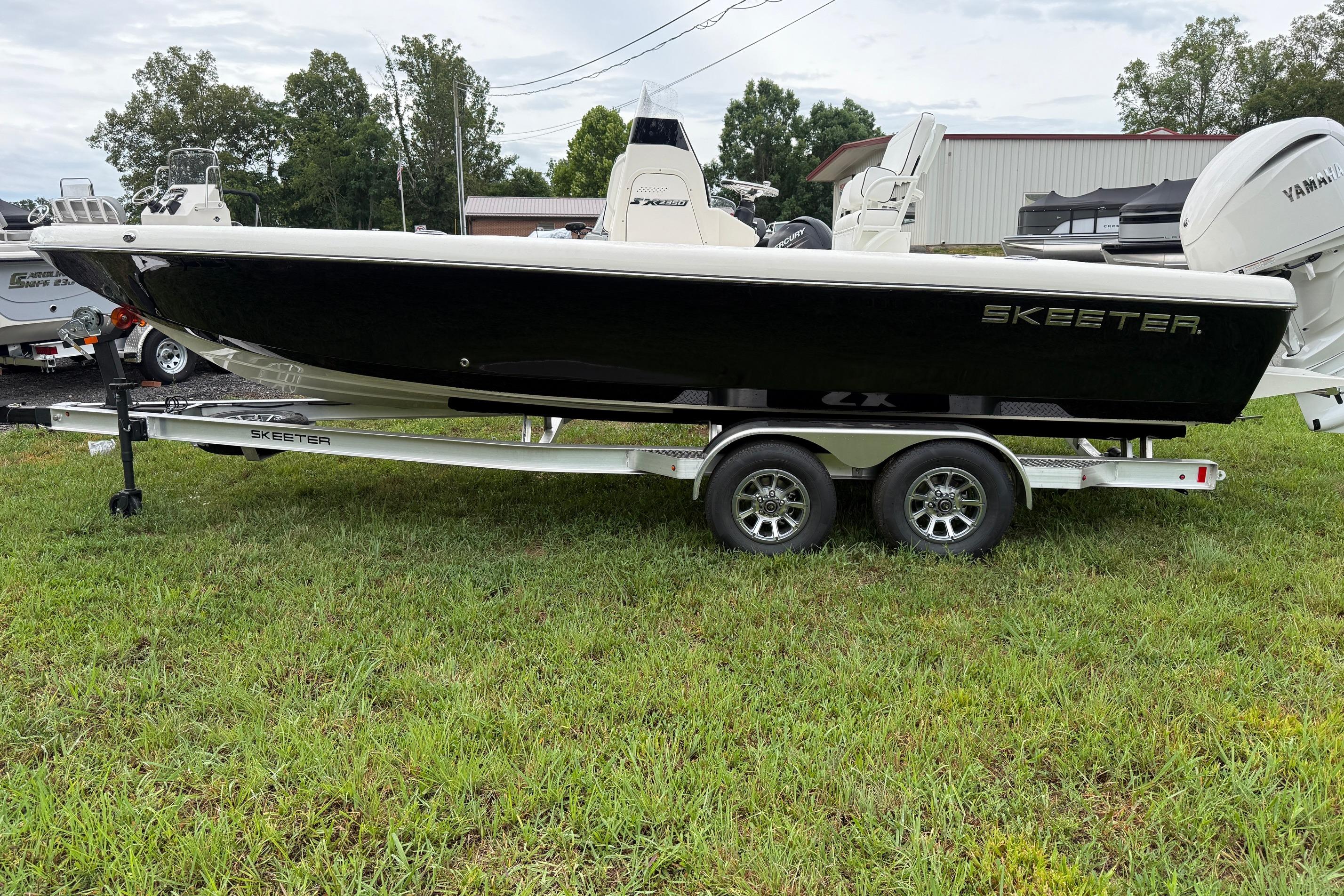 2026 Skeeter SX2350 boat on trailer, parked on grass, with Yamaha engine.