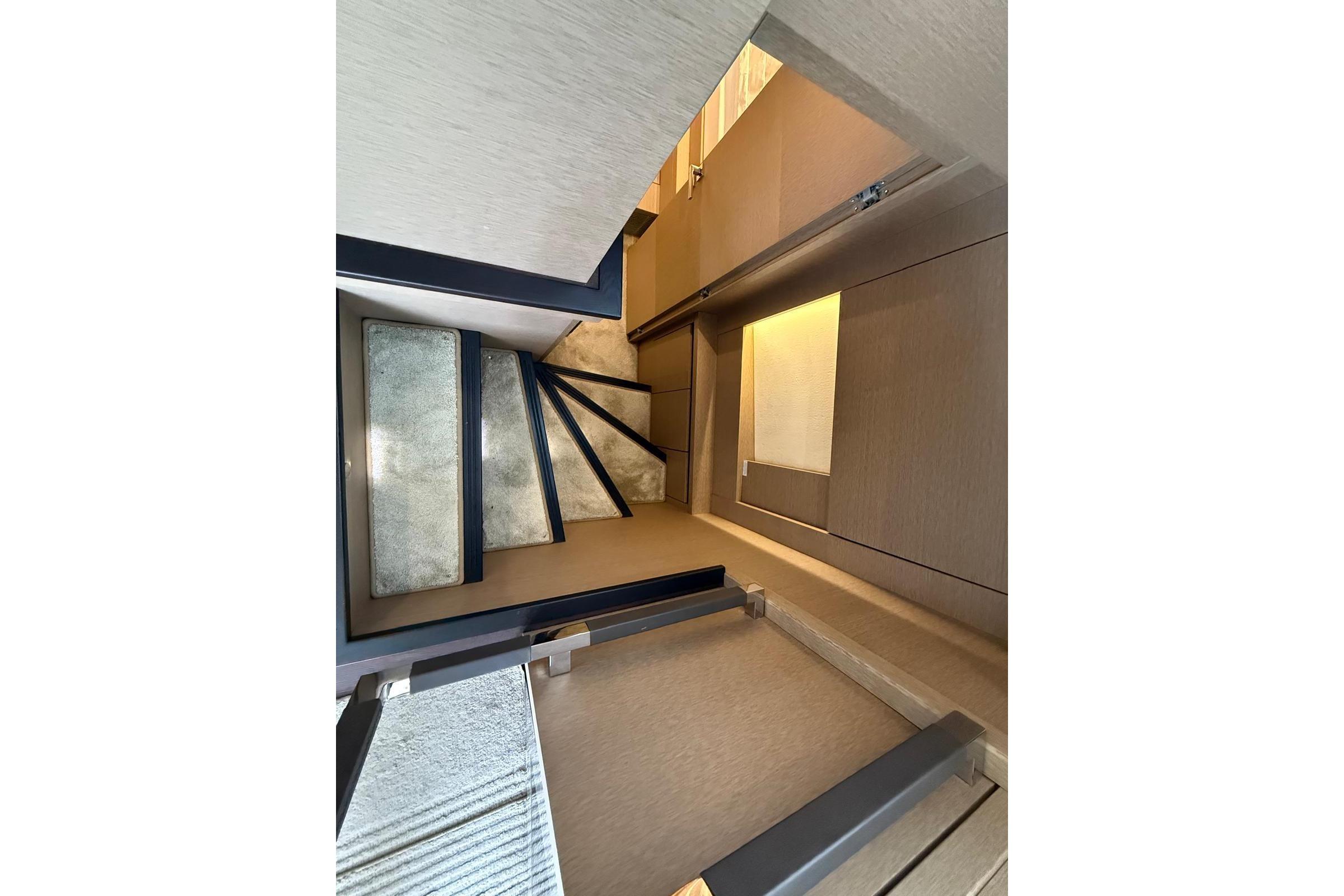 Staircase interior of 2019 Prestiage 630 yacht, featuring modern design and lighting.