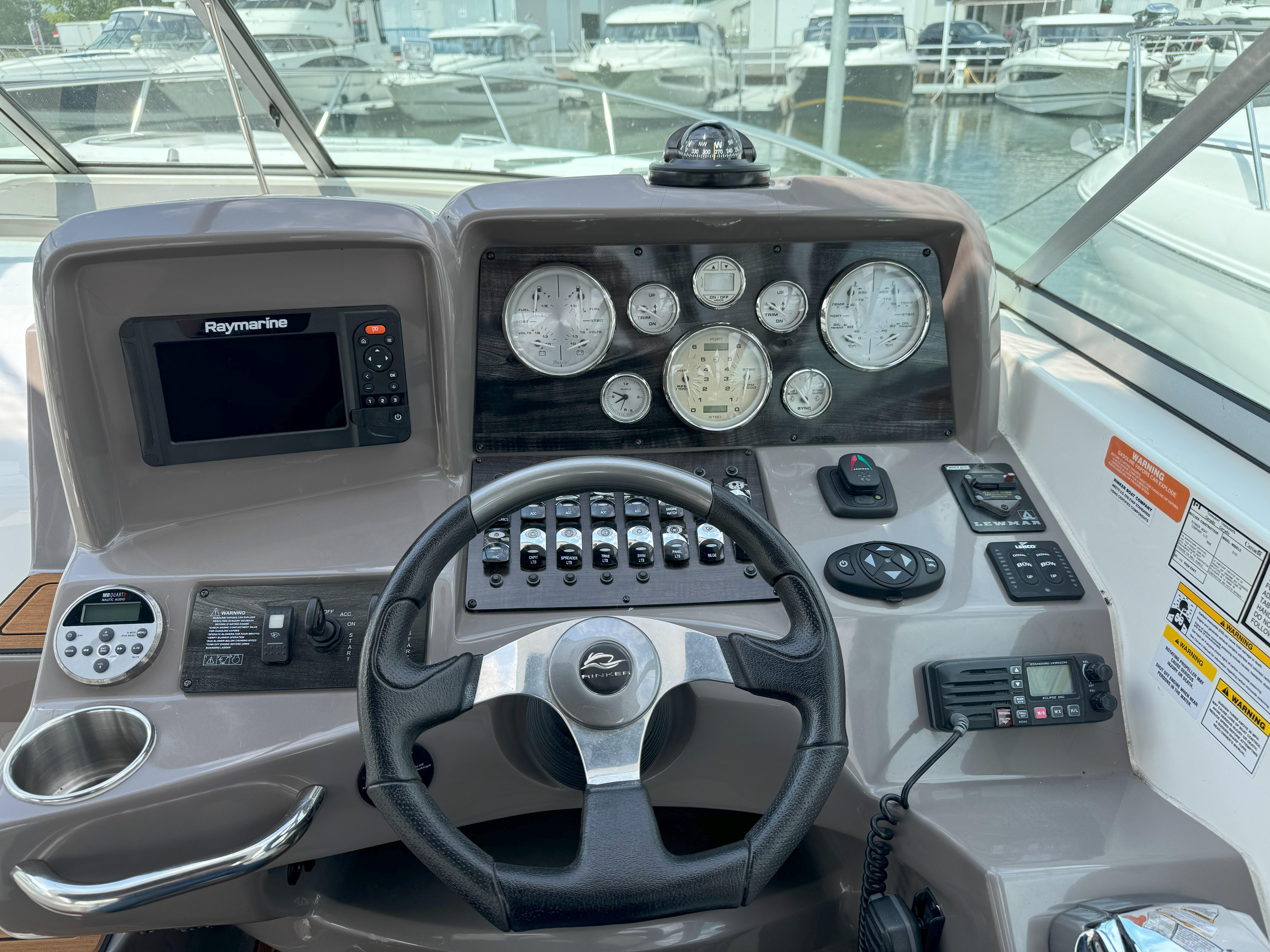 2010 Rinker 310 Express Cruiser helm with gauges and controls.