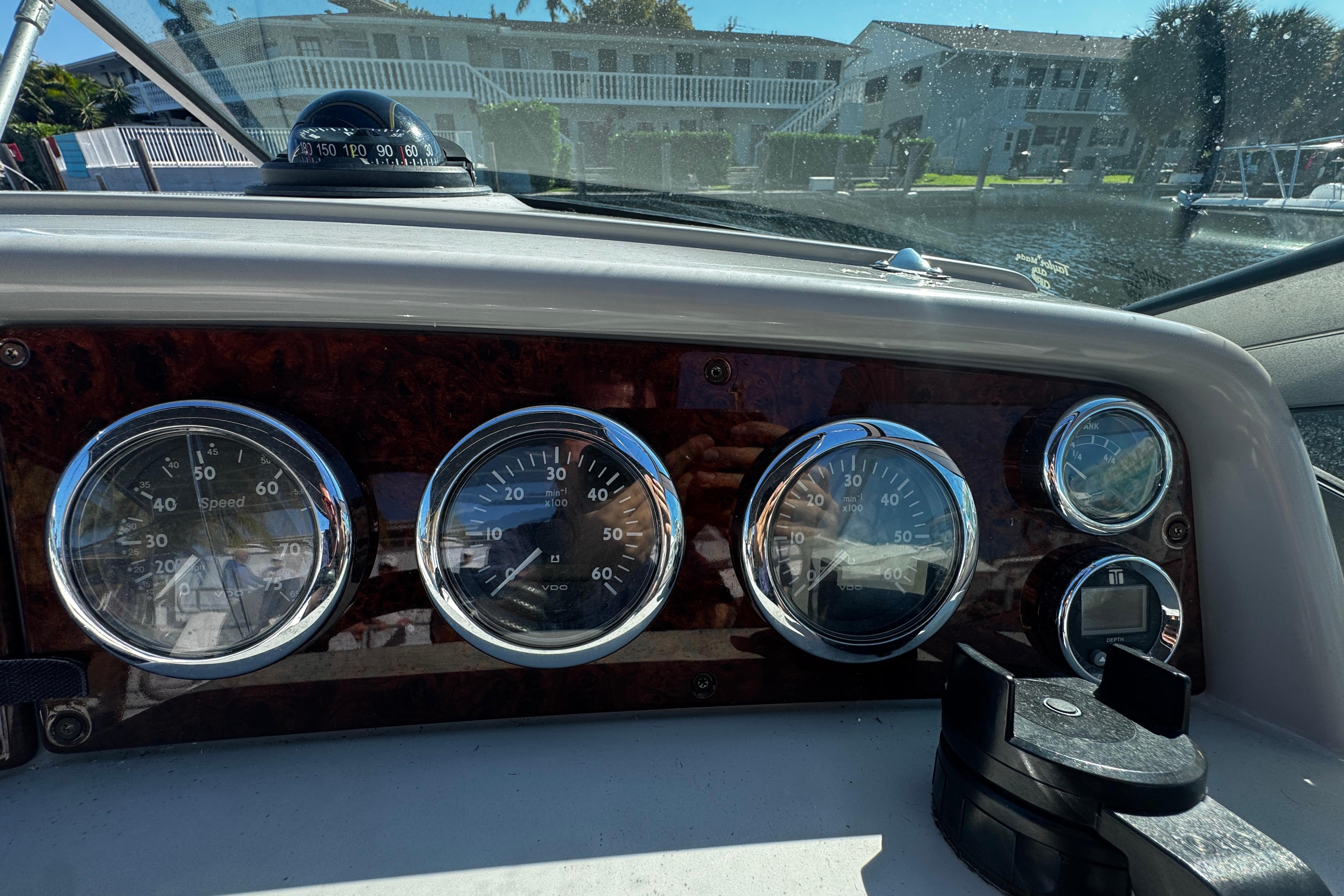 Dashboard of a 2004 Formula 280 Sun Sport boat with gauges and compass.