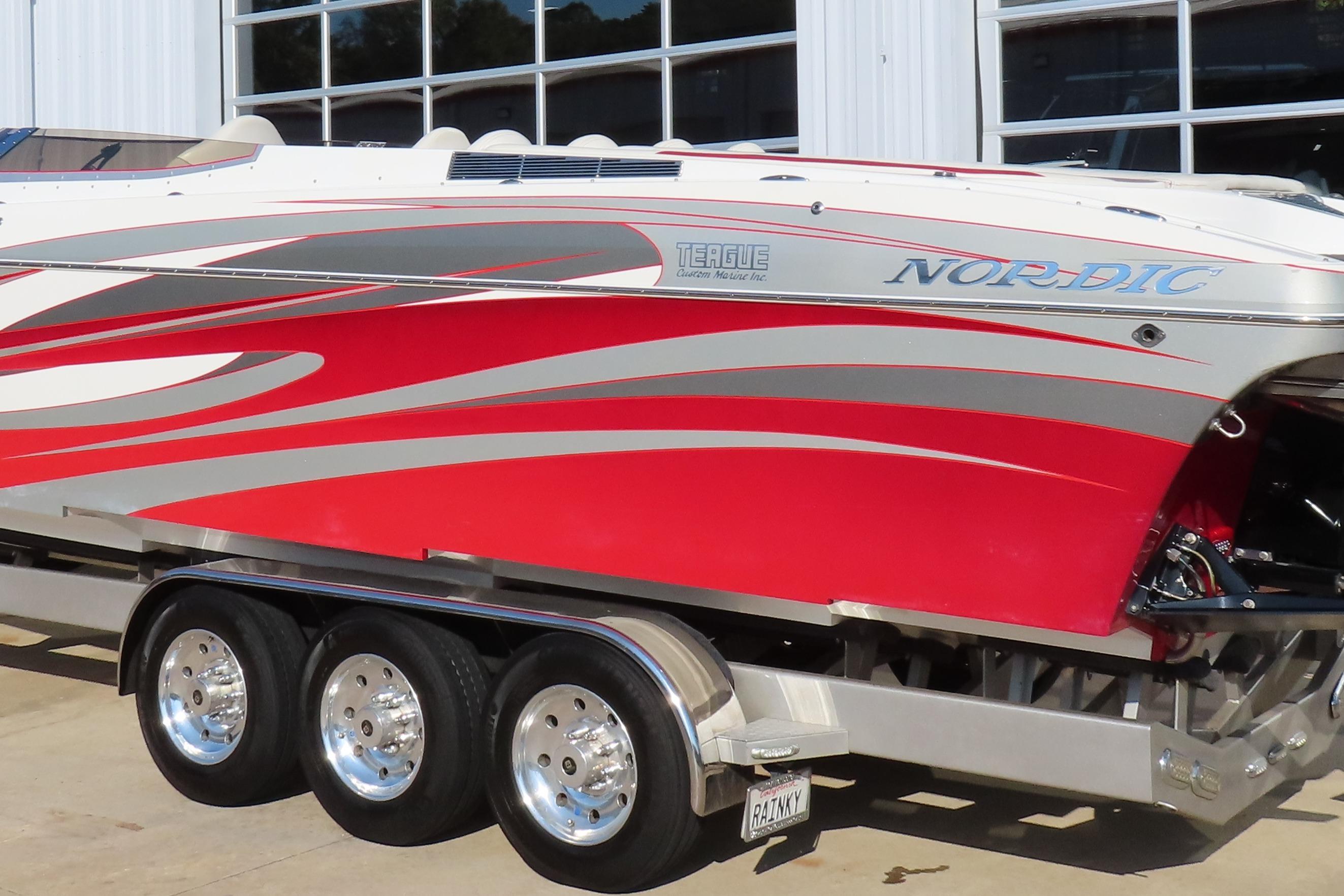 2013 Nordic 39 POKER RUN boat with red and silver design on a trailer.