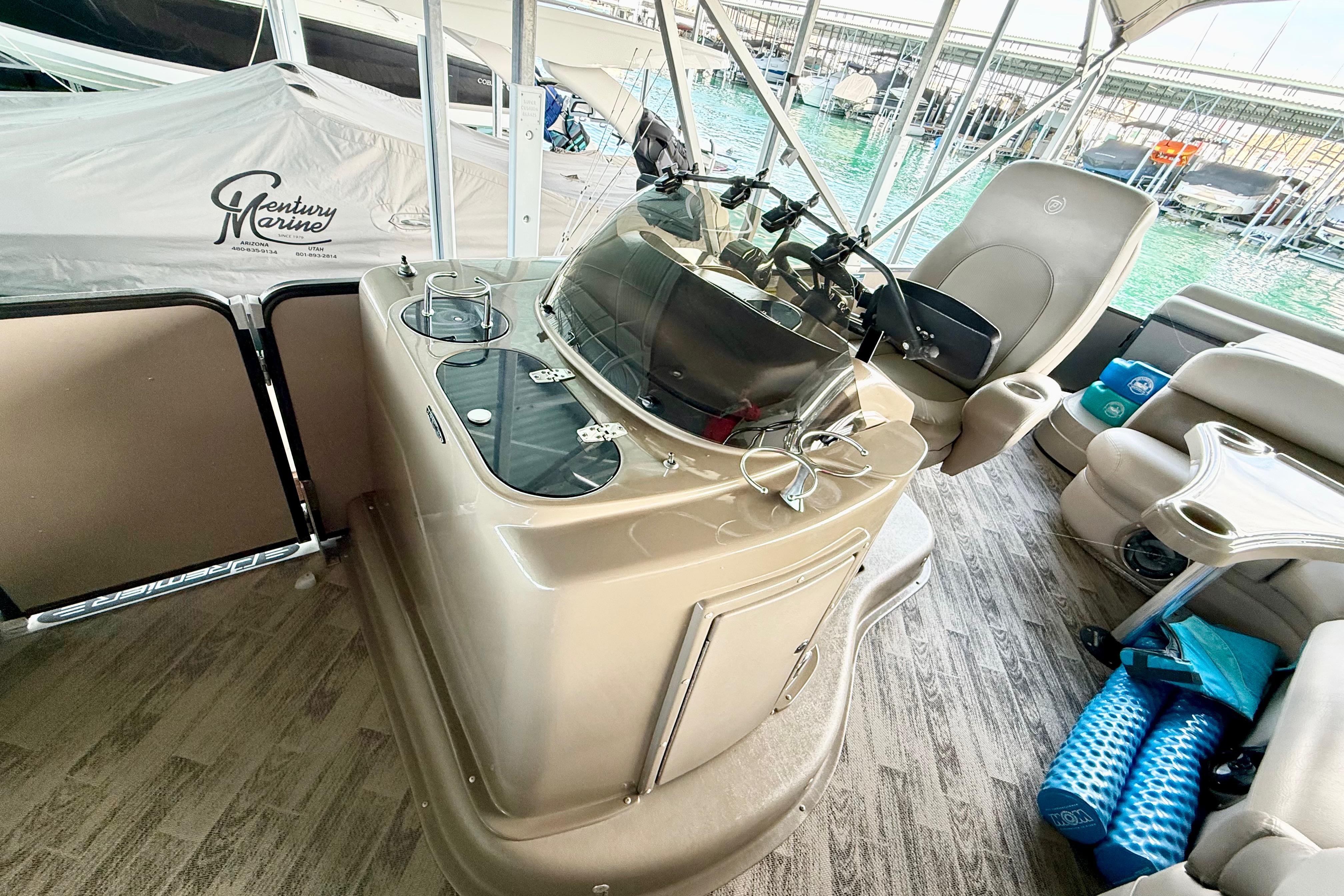 Interior of 2011 Premier 275 Grand Majestic PTX pontoon boat with helm and seating area.