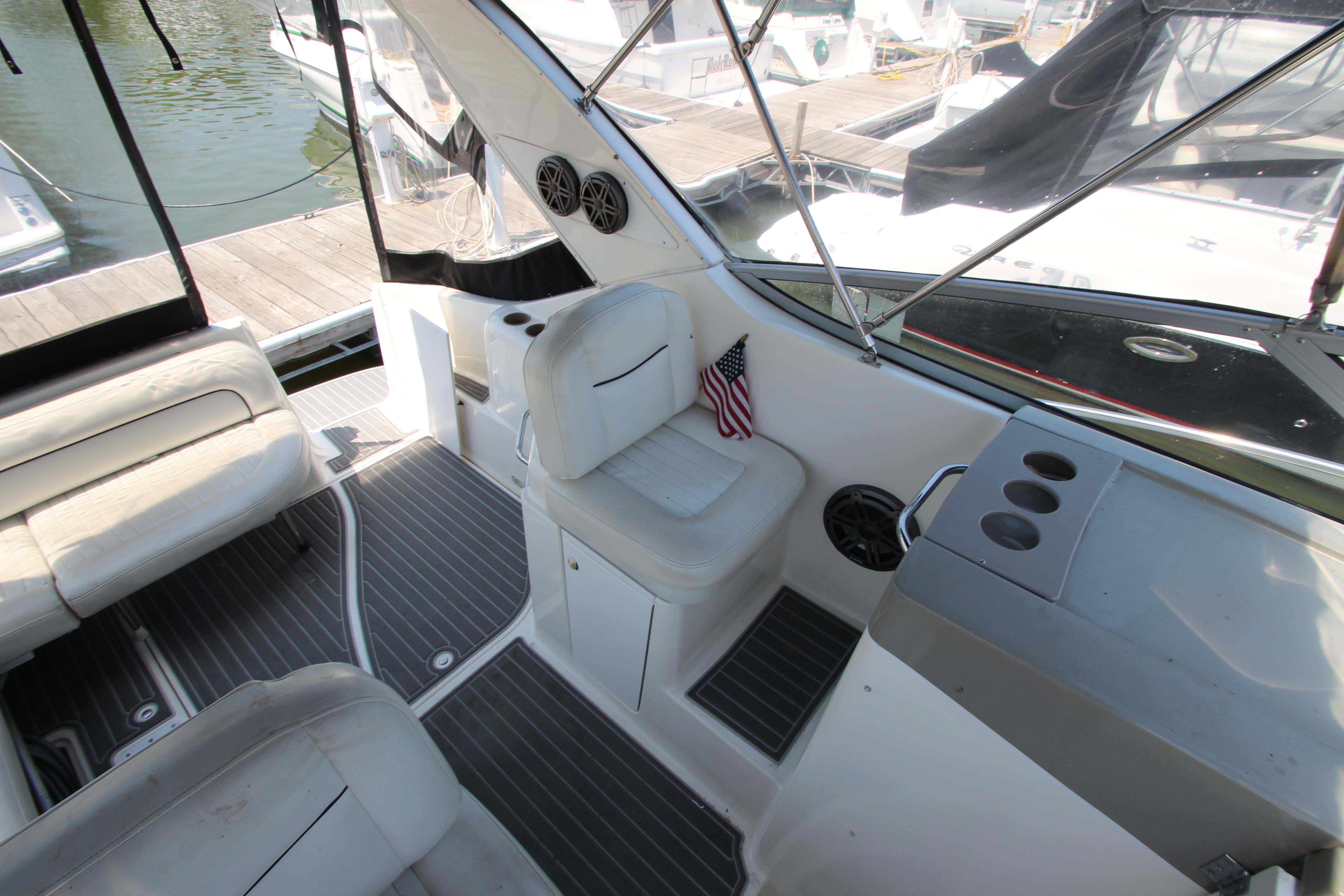 1999 Bayliner 3055 Ciera boat interior with seating, cup holders, and American flag.