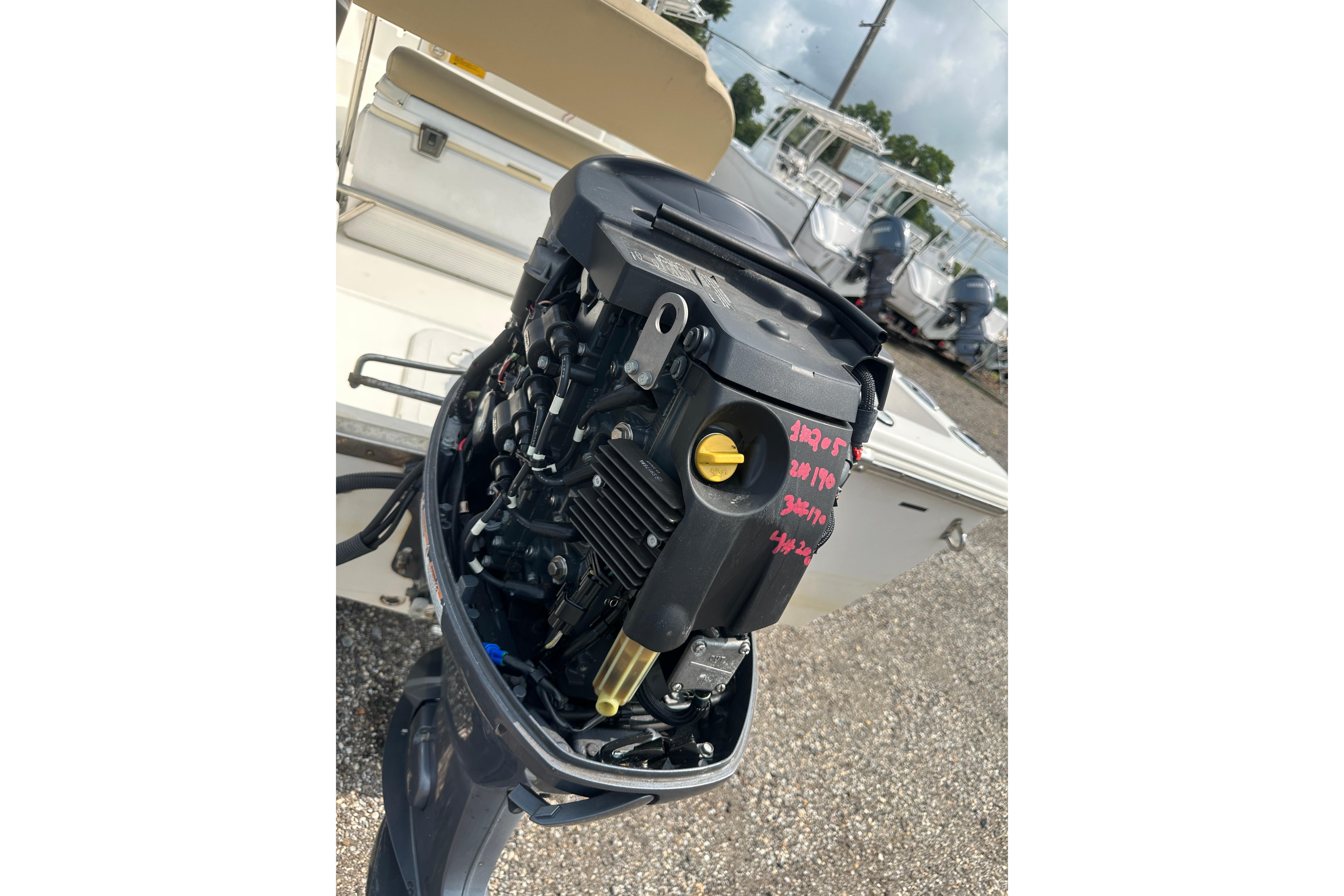 2018 Key West 1720 Center Console boat engine, detailed view in a marina setting.