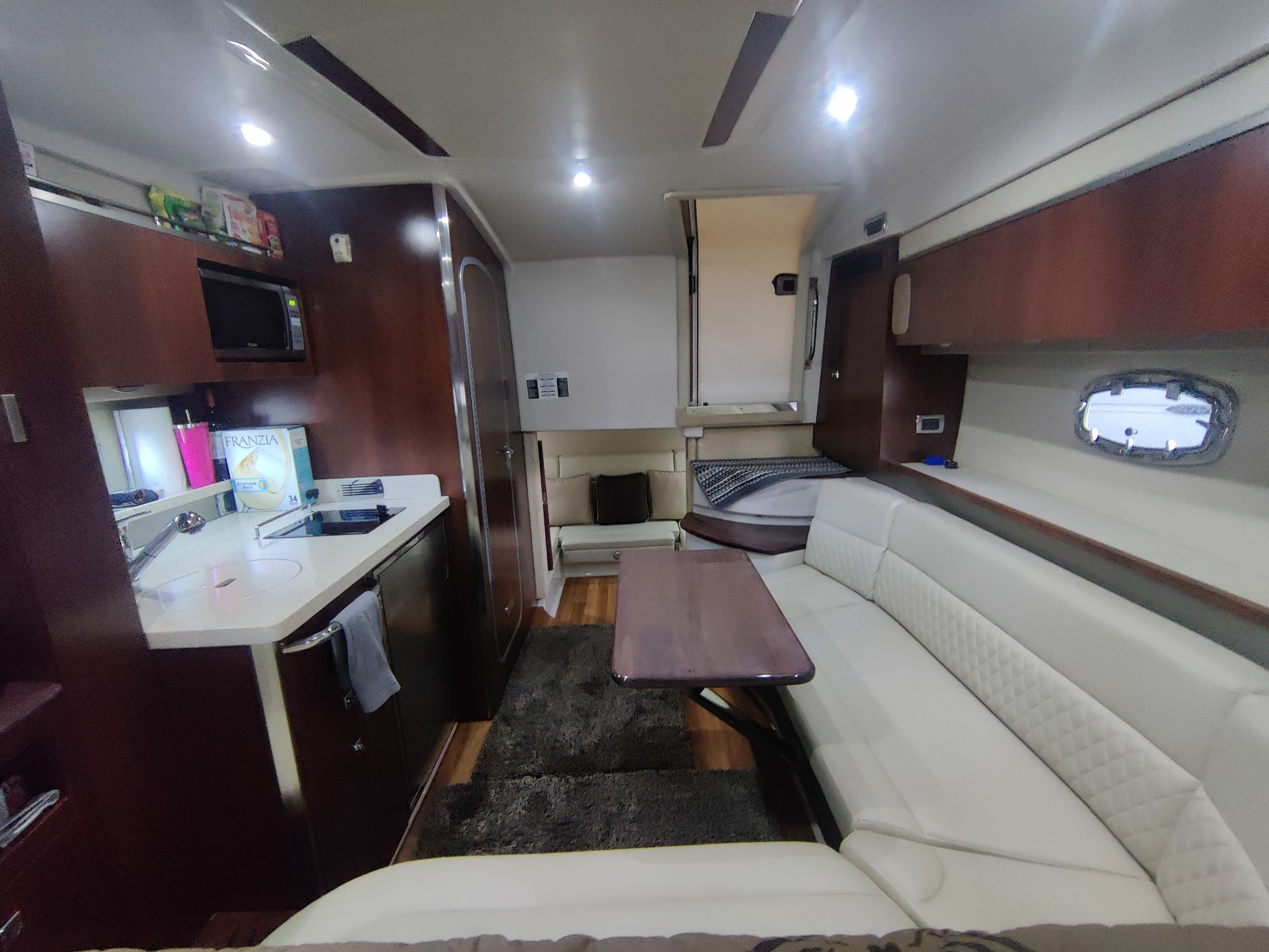 Interior of 2014 Chaparral 330 Signature with kitchen and seating area.