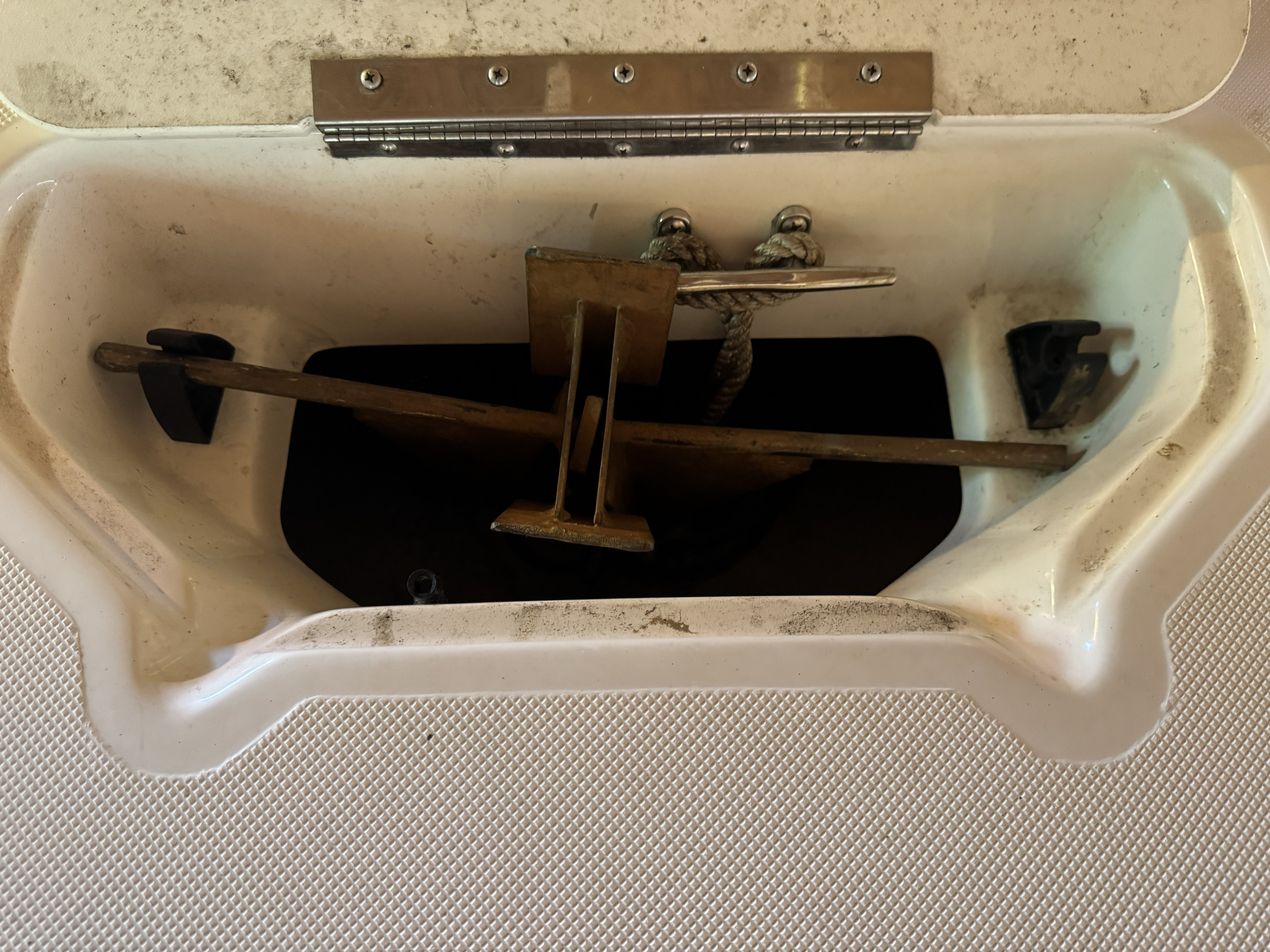 An anchor locker containing an anchor and rope inside.