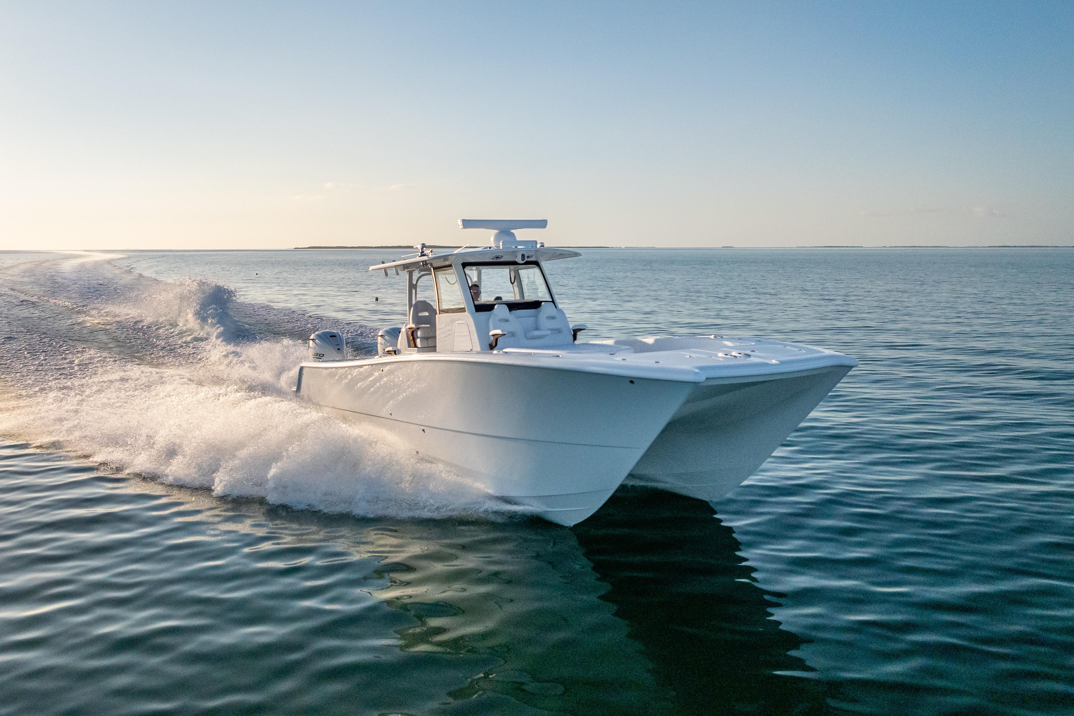 2026 Freeman 35 boat cruising on calm ocean waters at sunset.