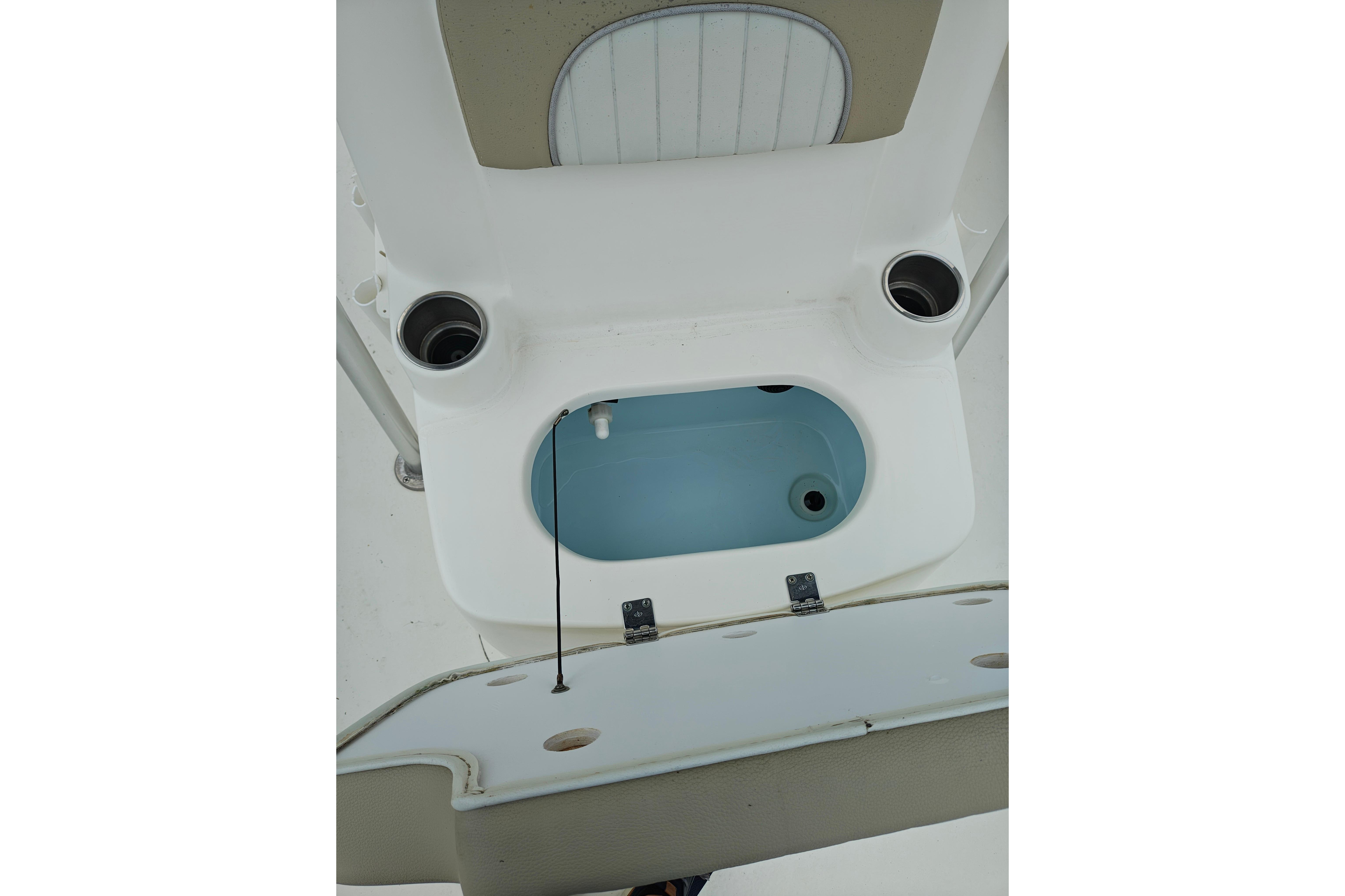 2018 Sundance B20CCR boat interior with open storage compartment and cup holders.