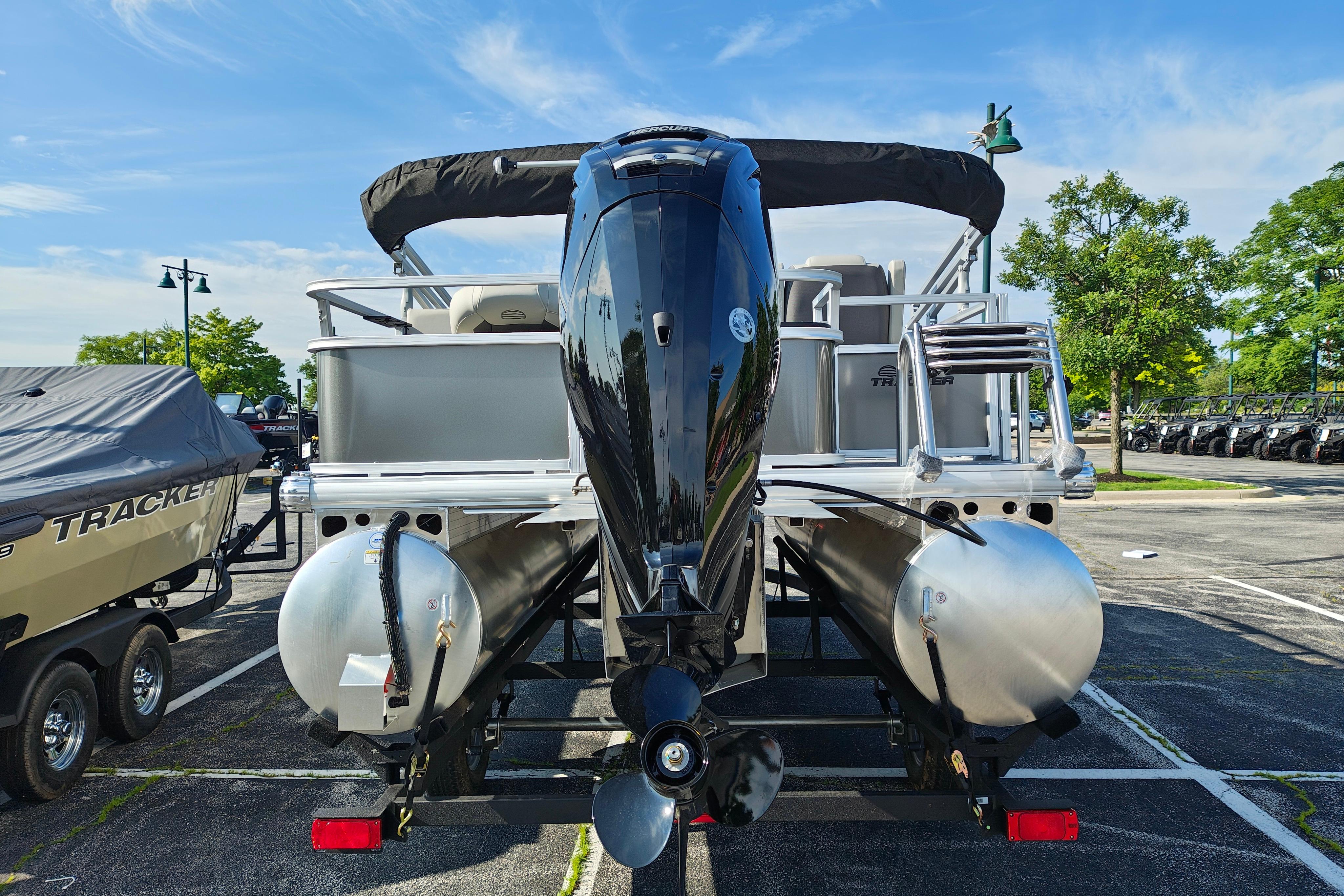 2026 Sun Tracker Bass Buggy 18 DLX pontoon boat, rear view in parking lot.