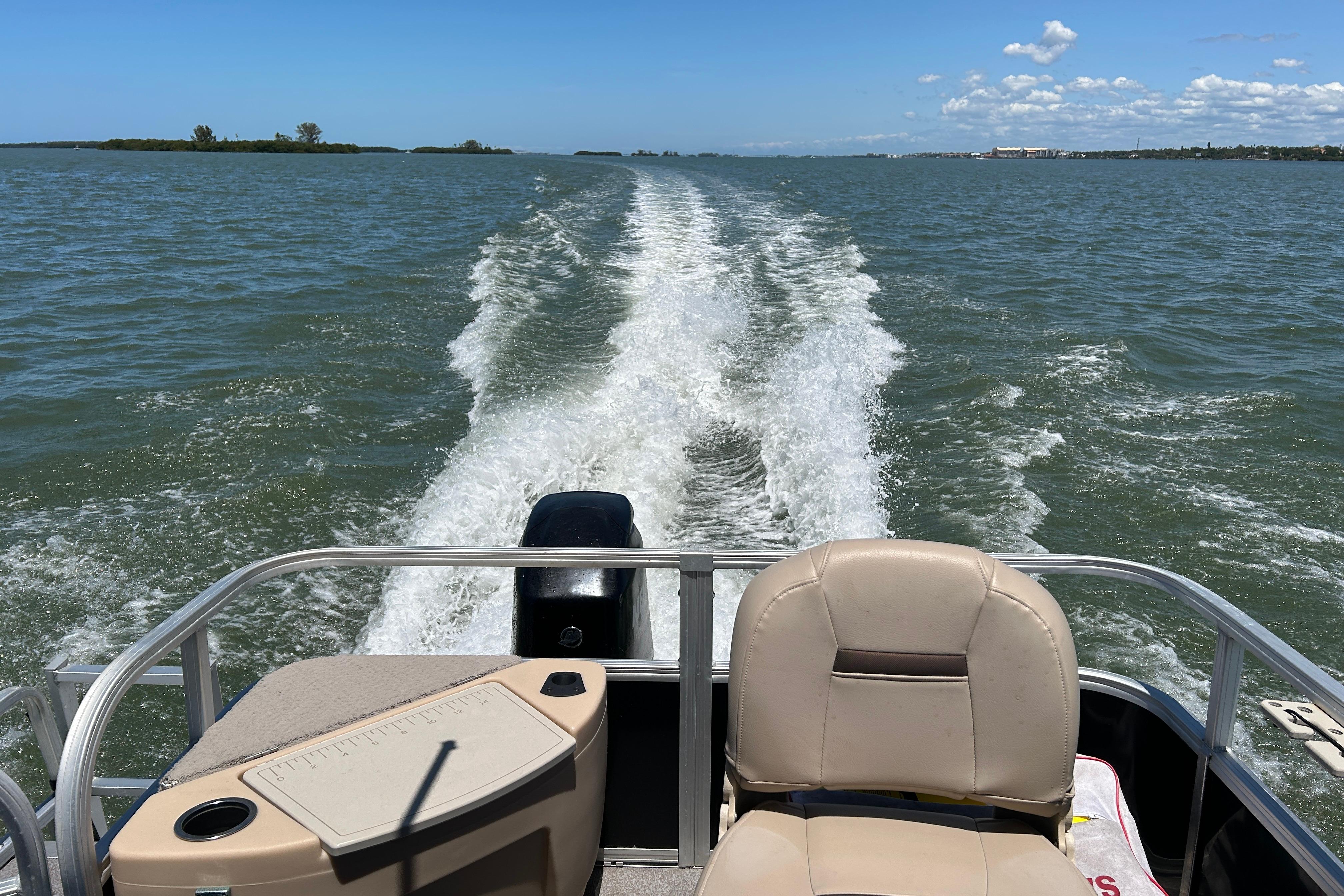 2017 Sun Tracker Bass Buggy 18 DLX cruising on open water, leaving a wake trail.