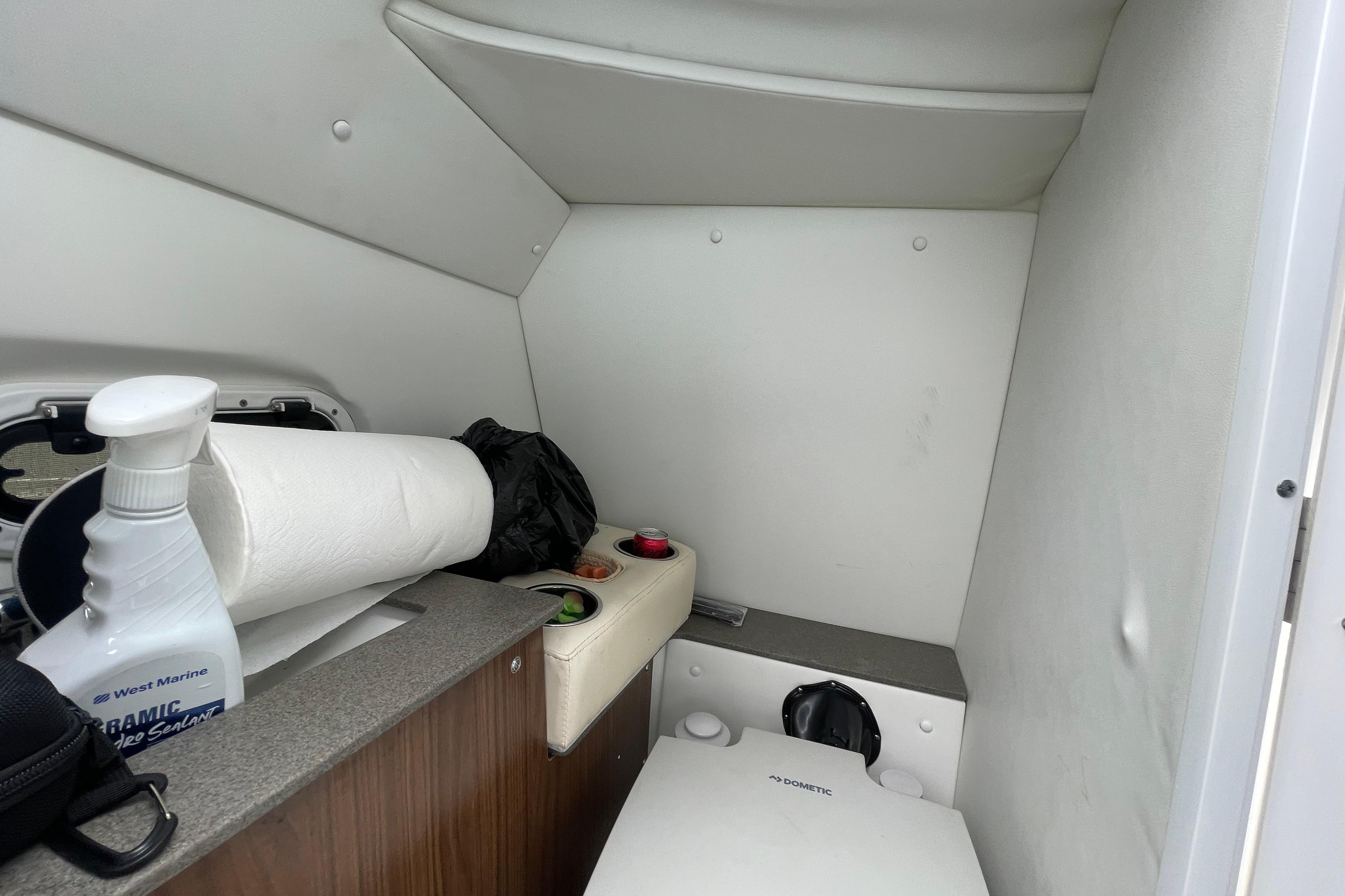 Interior of 2022 Four Winns HD8 OB boat with compact restroom amenities.