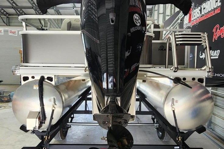 2026 Sun Tracker Bass Buggy 18 DLX pontoon boat, rear view in a showroom.