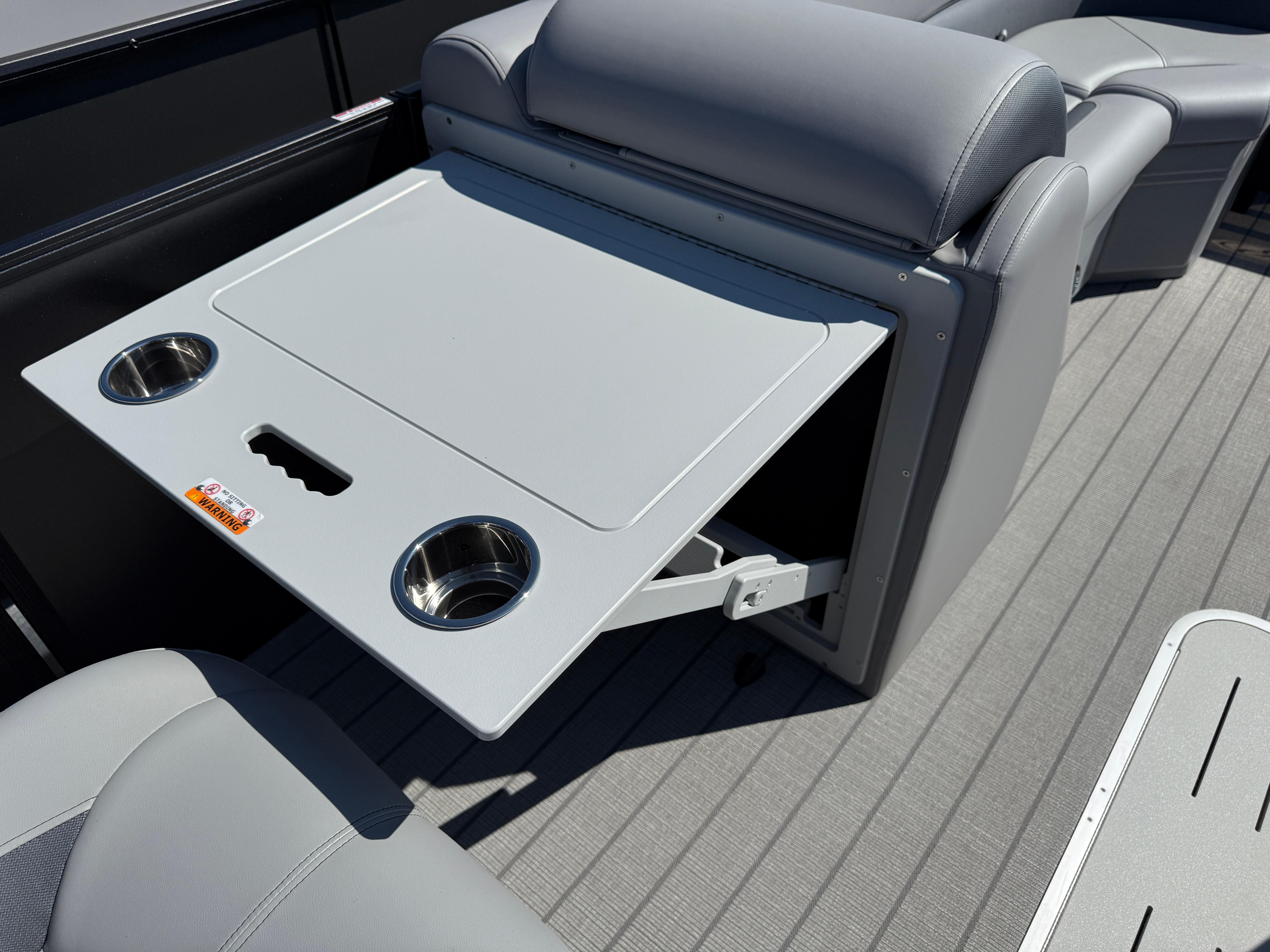 2026 Bentley Pontoons Legacy 223 Navigator interior with foldable table and cup holders.