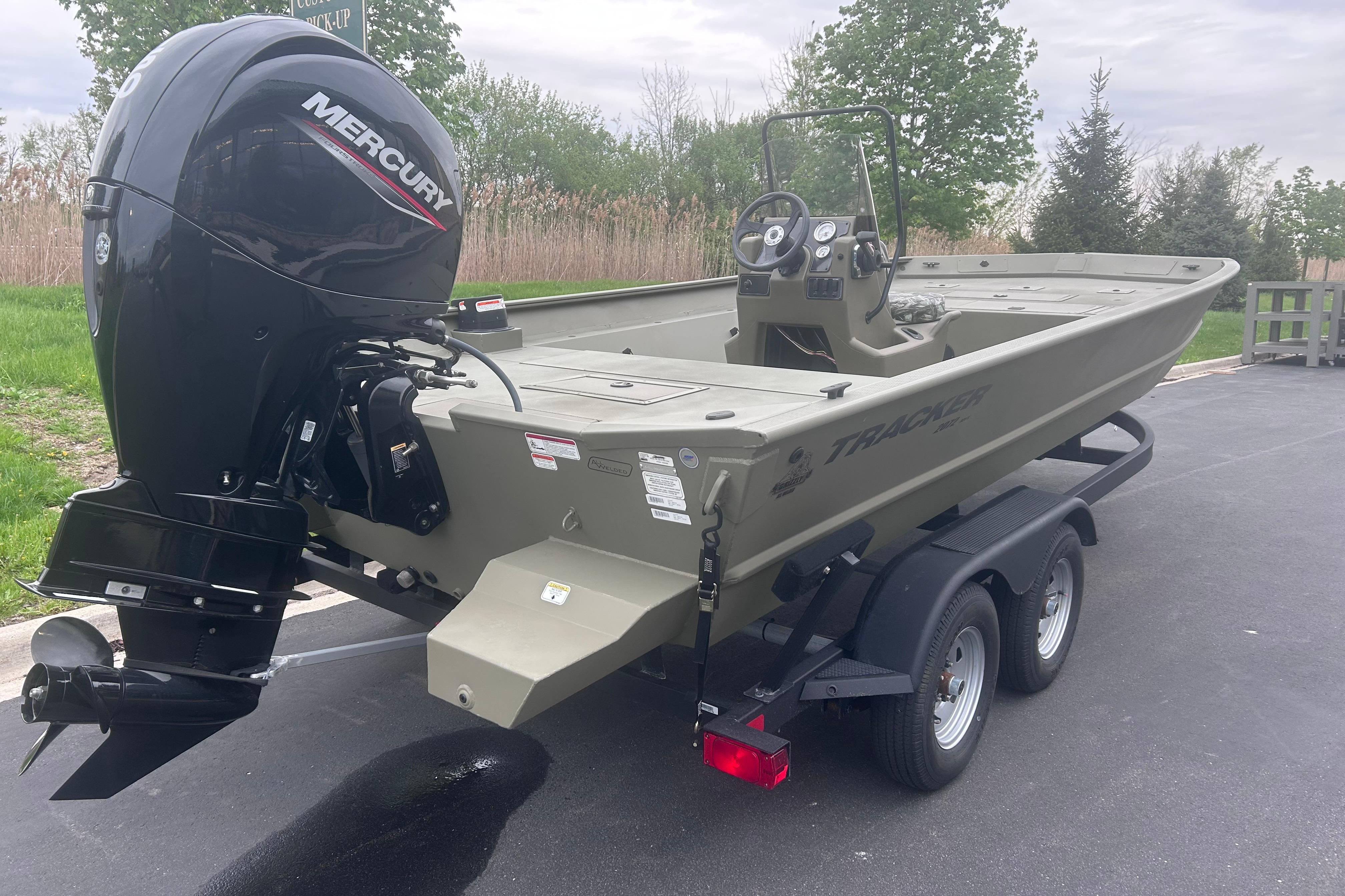 2024 Tracker Grizzly 2072 CC boat with Mercury engine on trailer.