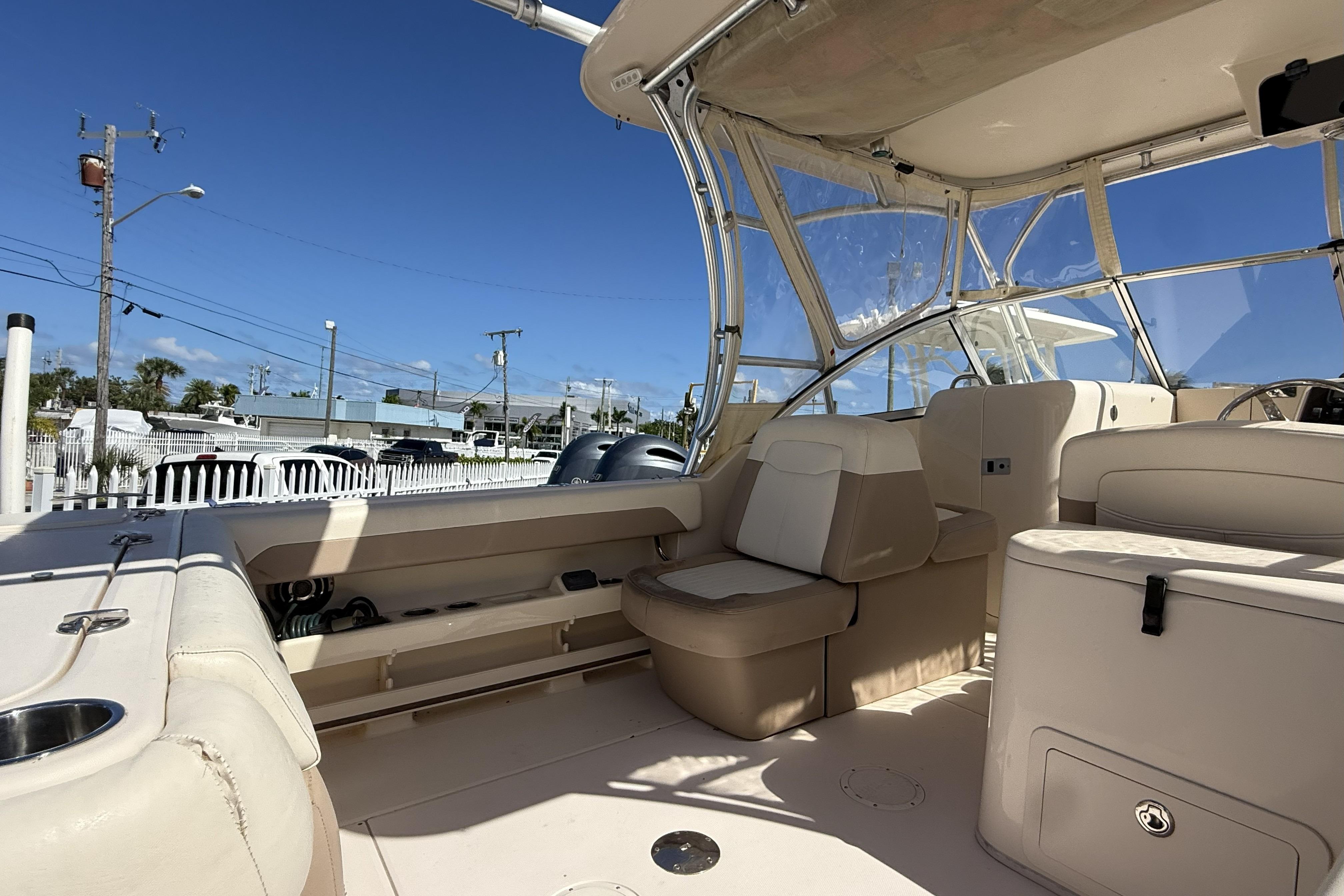 2014 Grady-White Freedom 275 boat interior with beige seating and clear canopy.