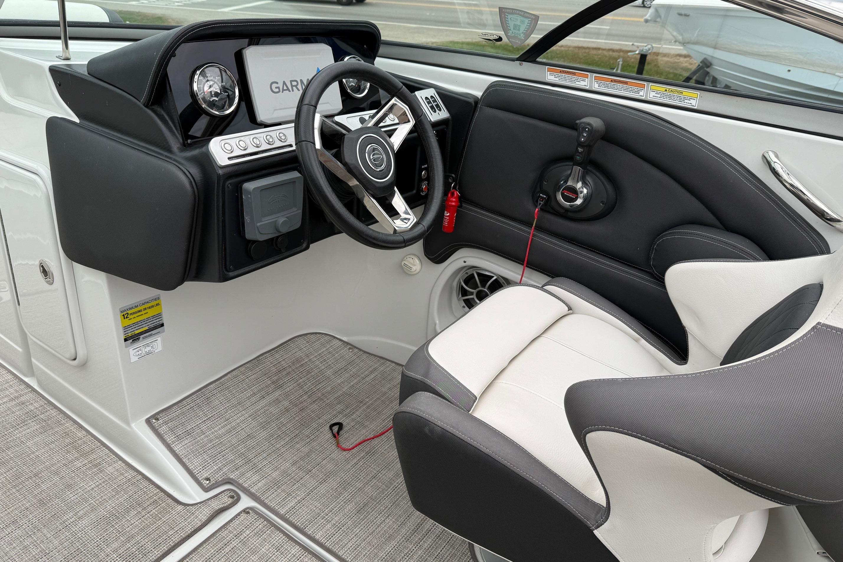 2022 Crownline 255 SS boat cockpit with steering wheel and Garmin display.
