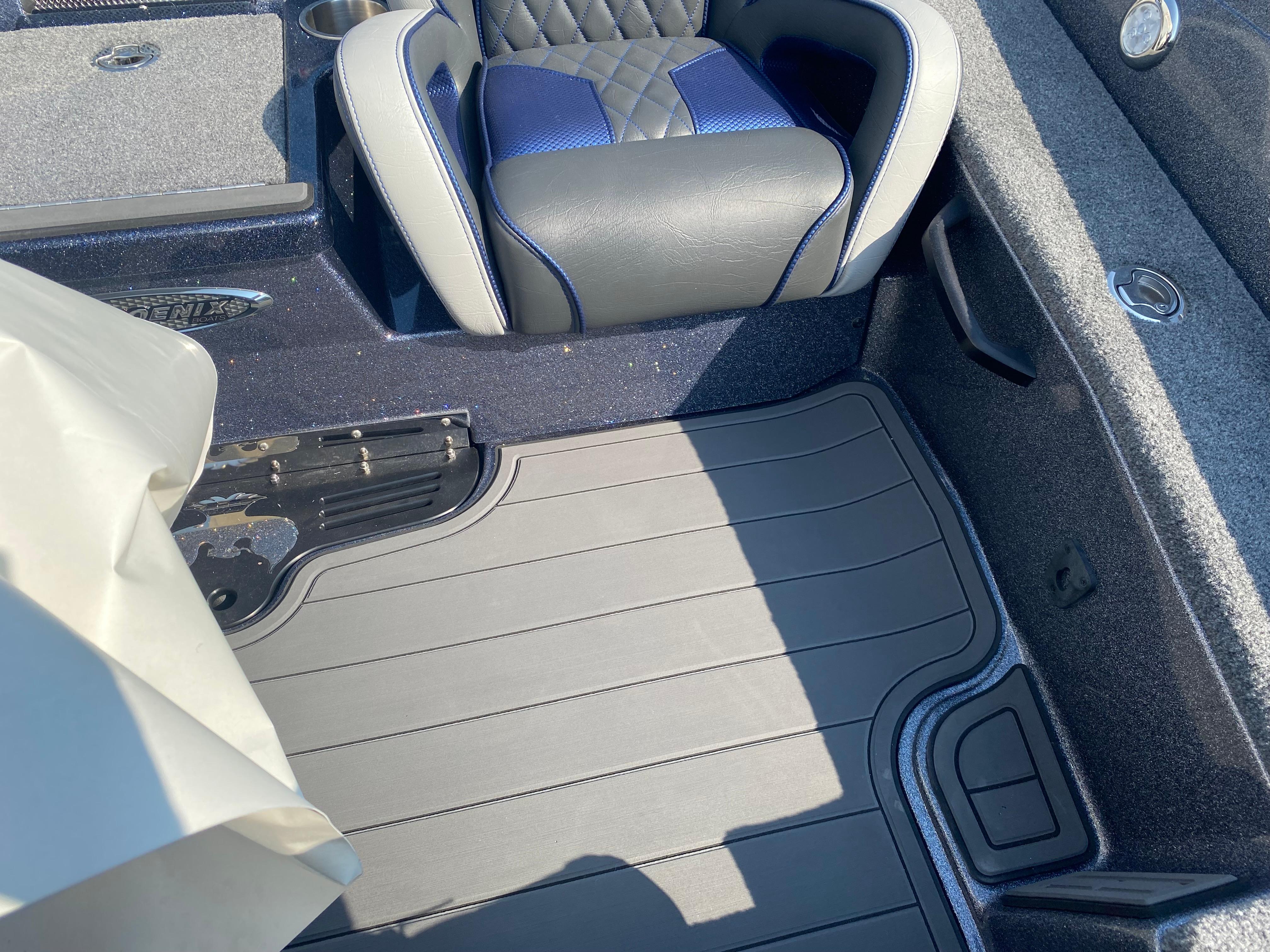 Interior of 2026 Phoenix 921 2 Elite X boat, featuring cushioned seating and textured flooring.