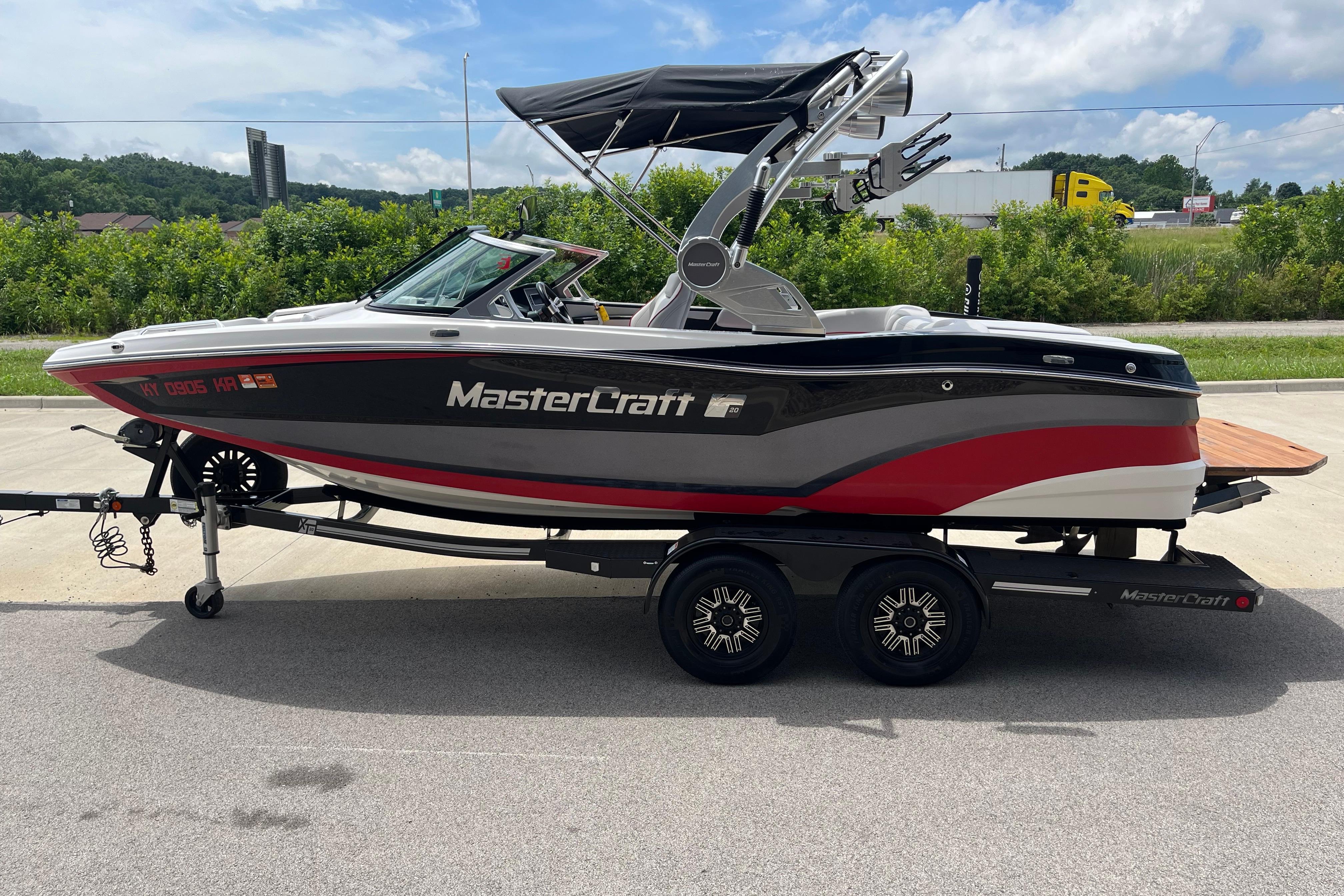 2019 MasterCraft XT20 boat on trailer, sleek design with red and black accents.