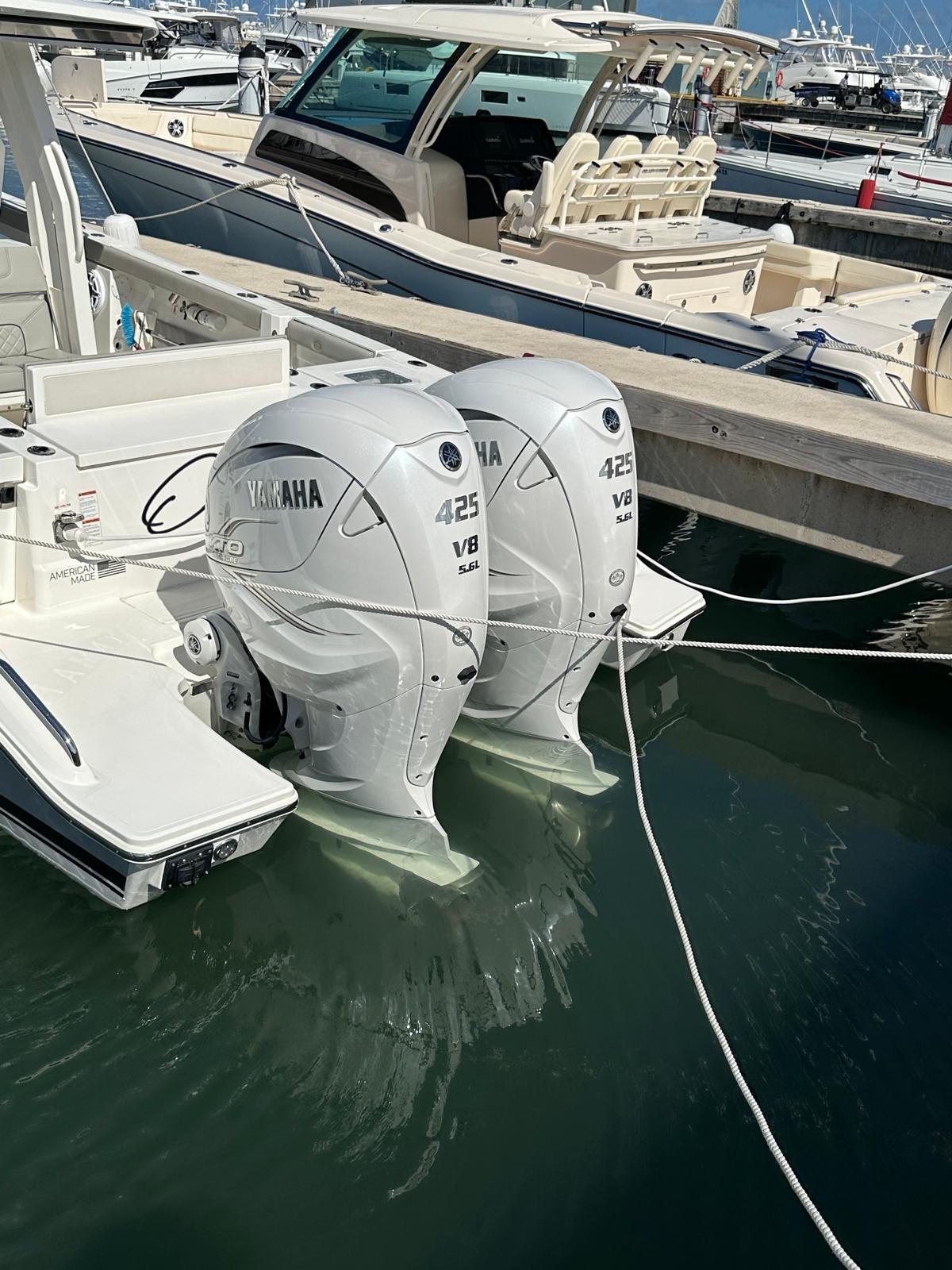 2023 Pursuit S 358 Sport boat with twin Yamaha 425 V8 engines docked in marina.
