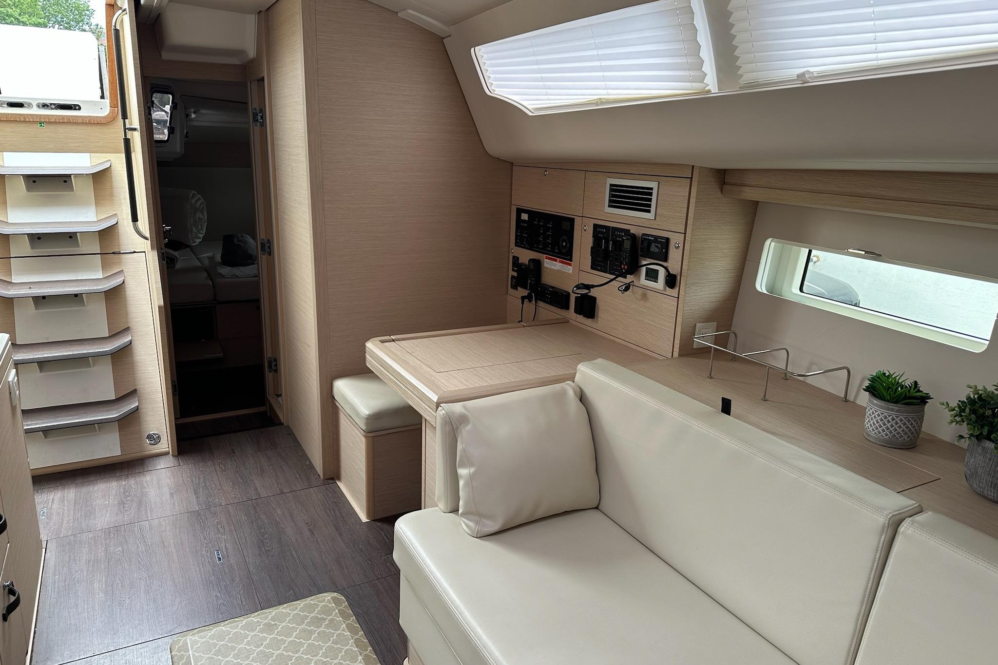 Interior of a 2018 Jeanneau 51 yacht with modern furnishings and control panel.