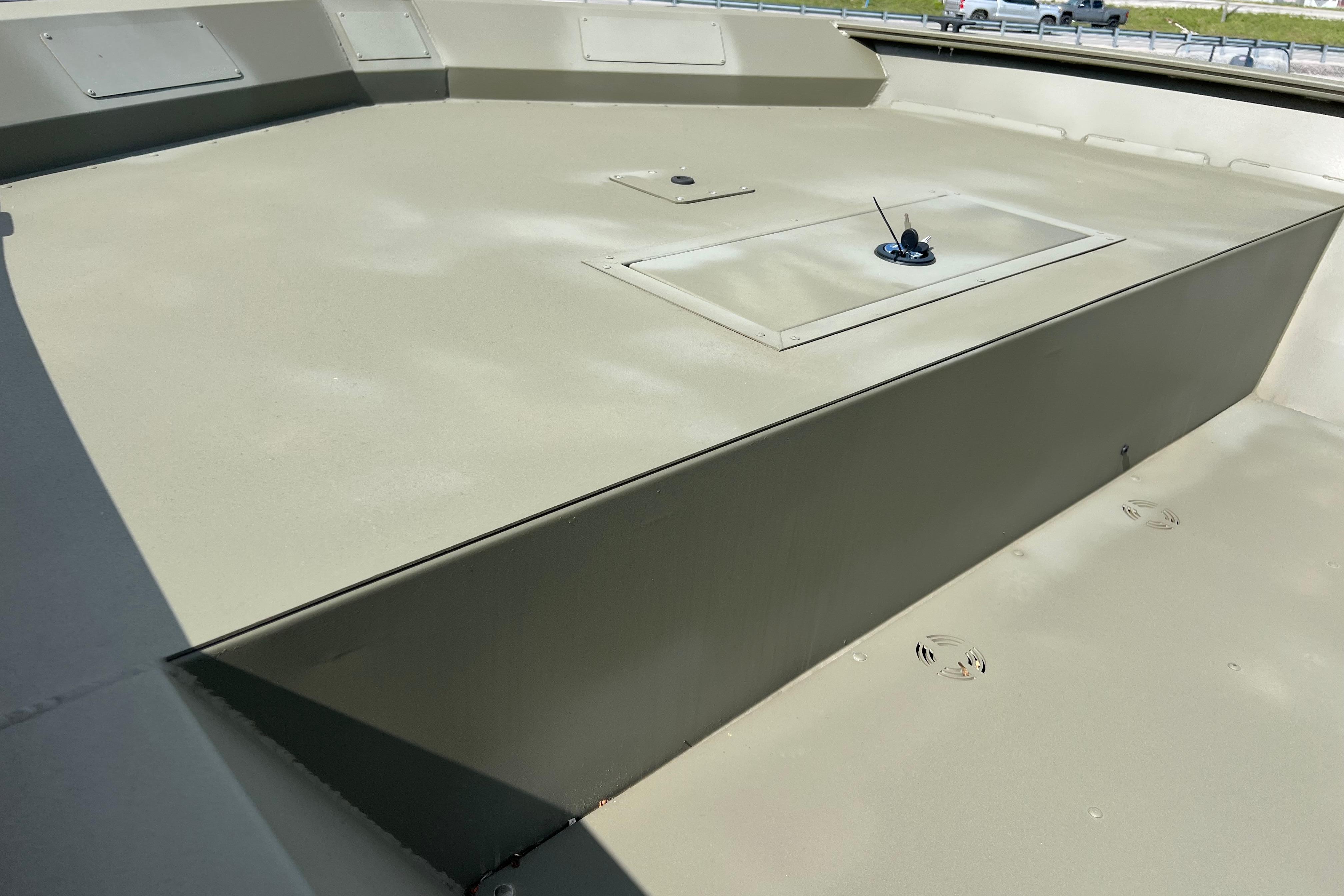 2025 Tracker Grizzly 2072 Utility boat deck, showcasing storage hatch and durable design.