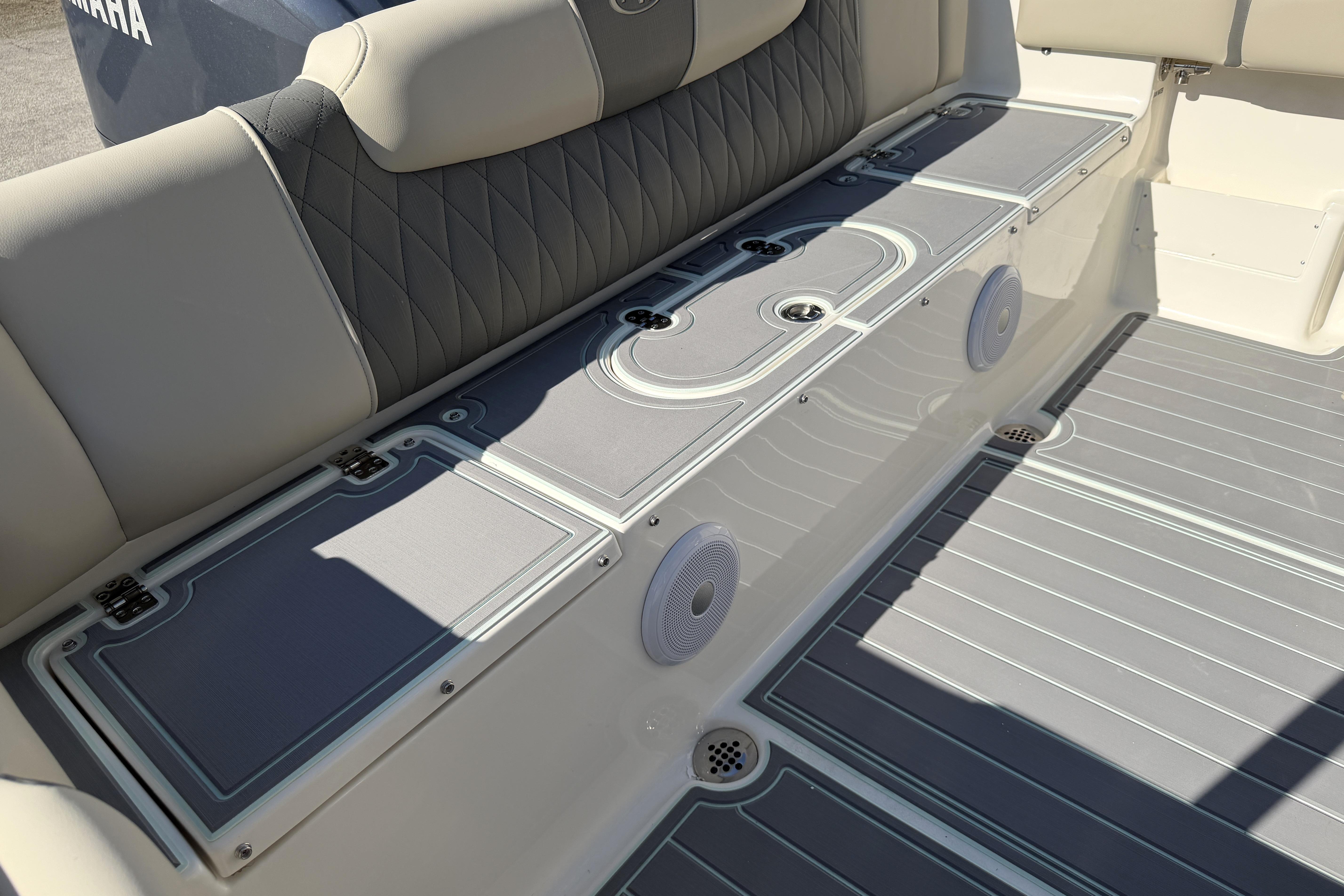 2025 Key West 239 FS boat interior with cushioned seating and storage compartments.