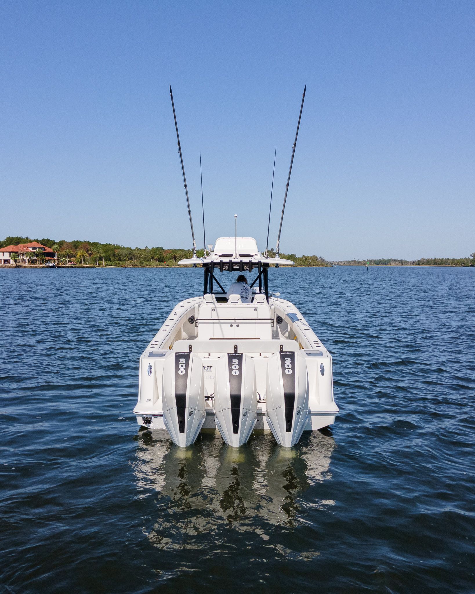 A 2022 SeaVee 370Z on calm water with four outboard engines.