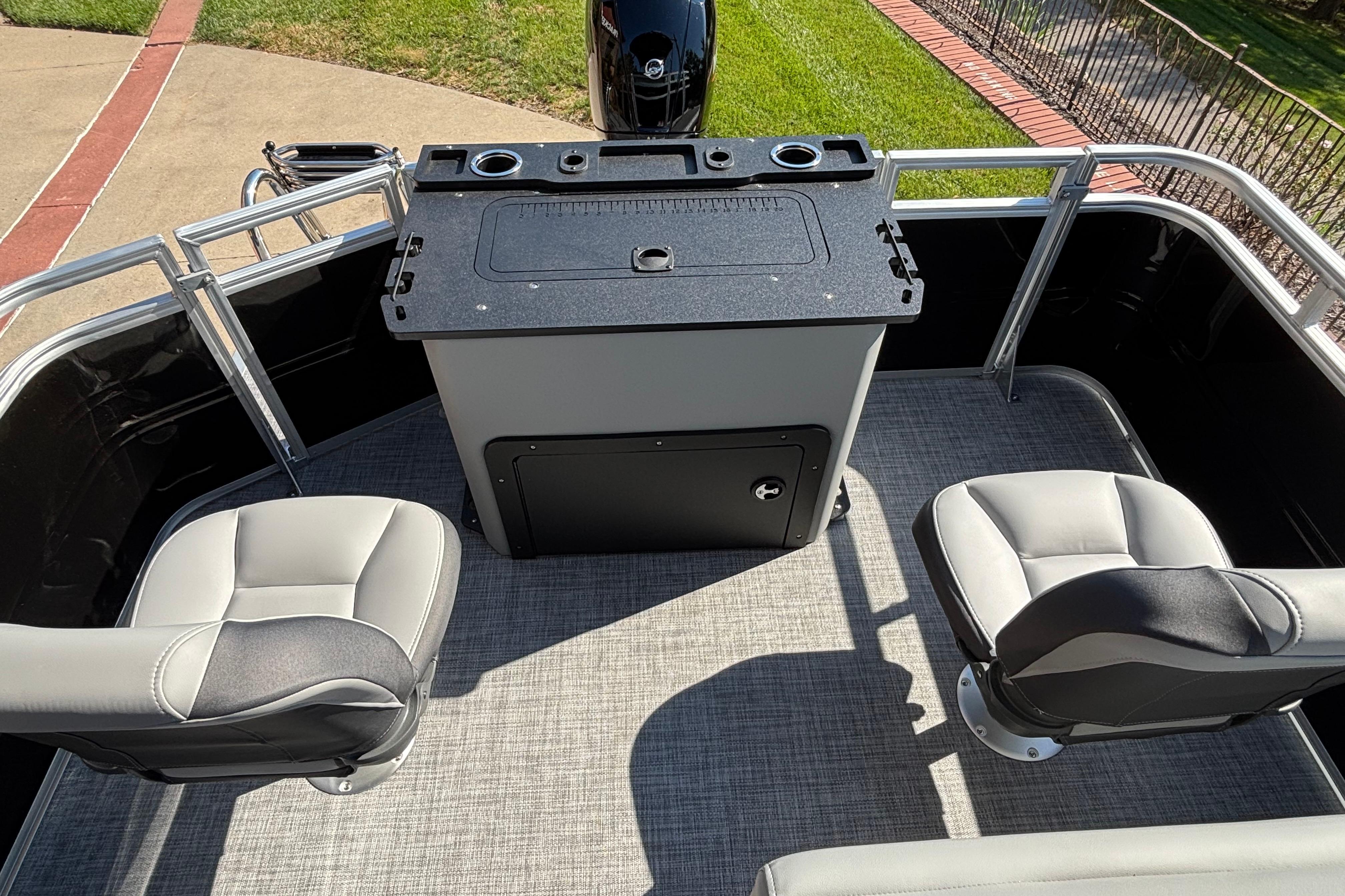 2026 Sun Tracker SportFish 22 DLX boat interior with seating and control panel.