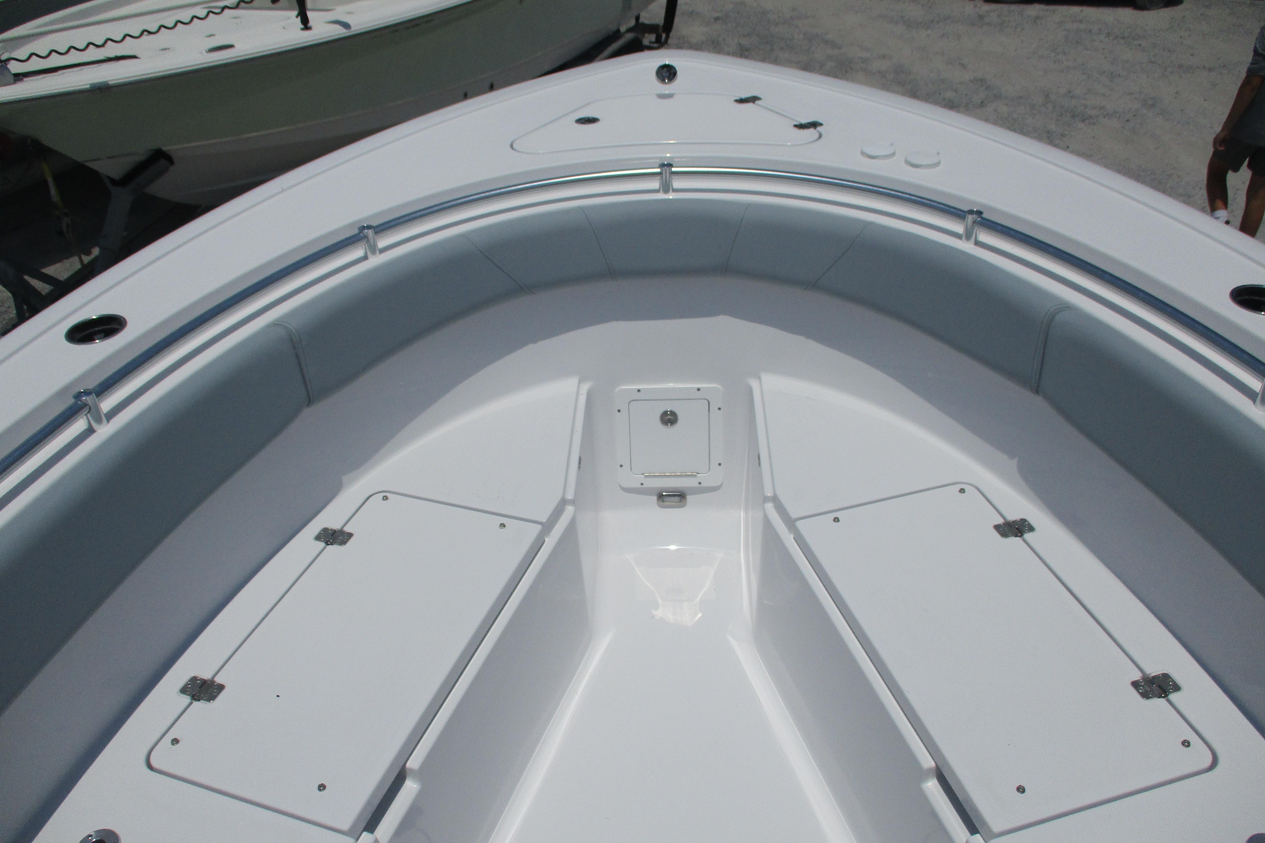 2027 Sportsman Open 252 Center Console boat interior with cushioned seating and storage compartments.