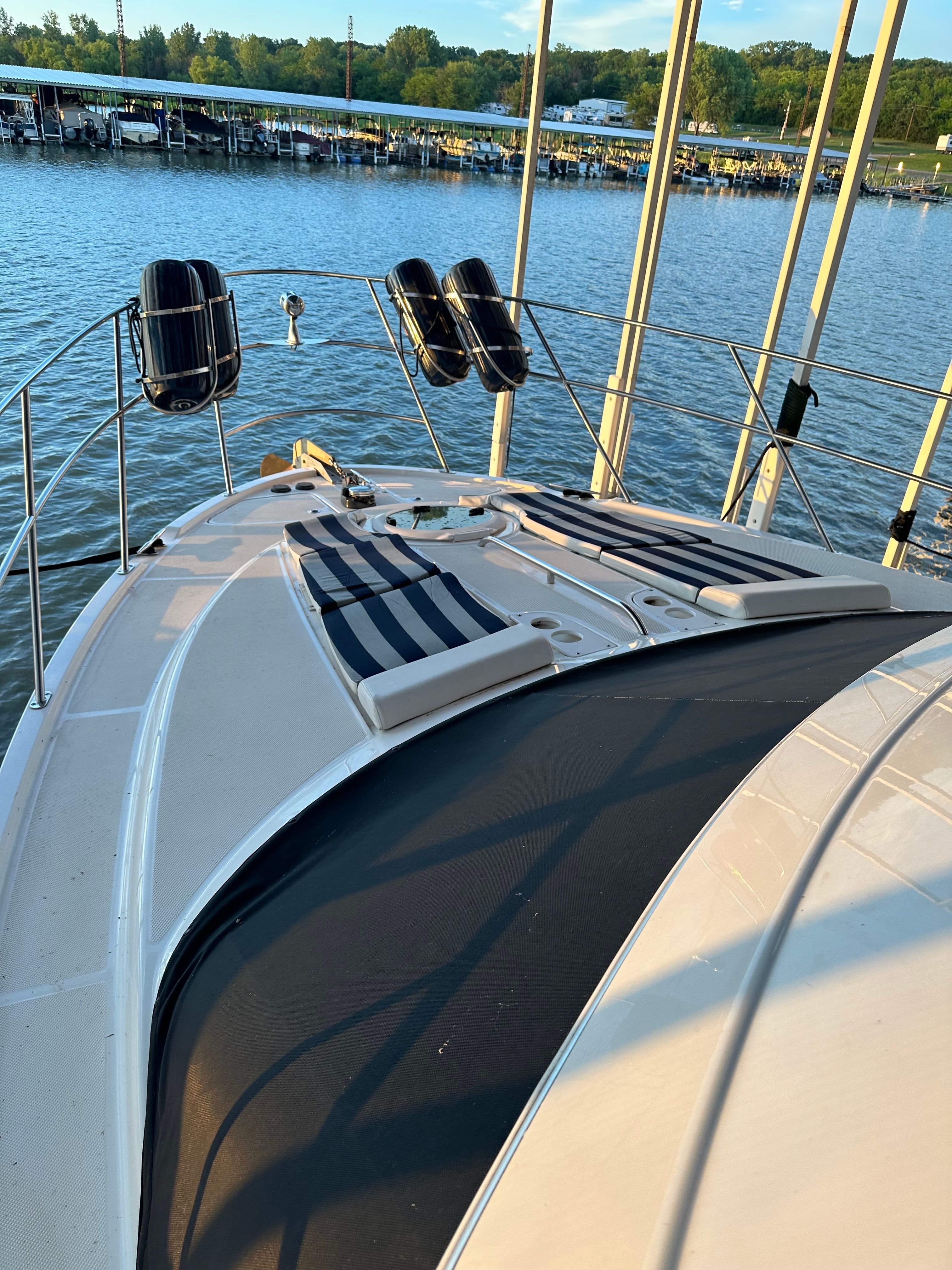 2007 Meridian 459 Motoryacht on calm water at sunset.