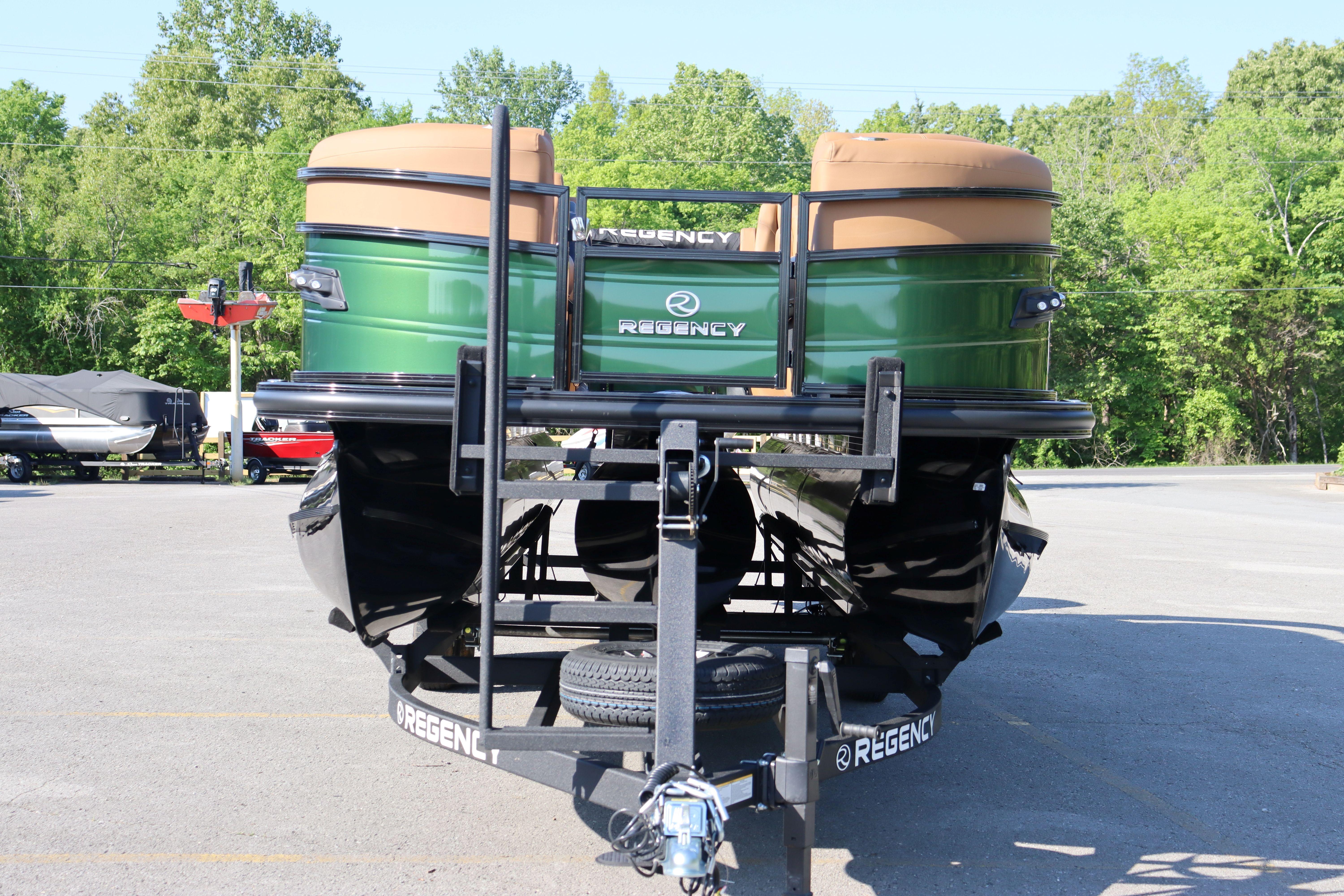 2026 Regency 230 DL pontoon boat on trailer in parking lot.