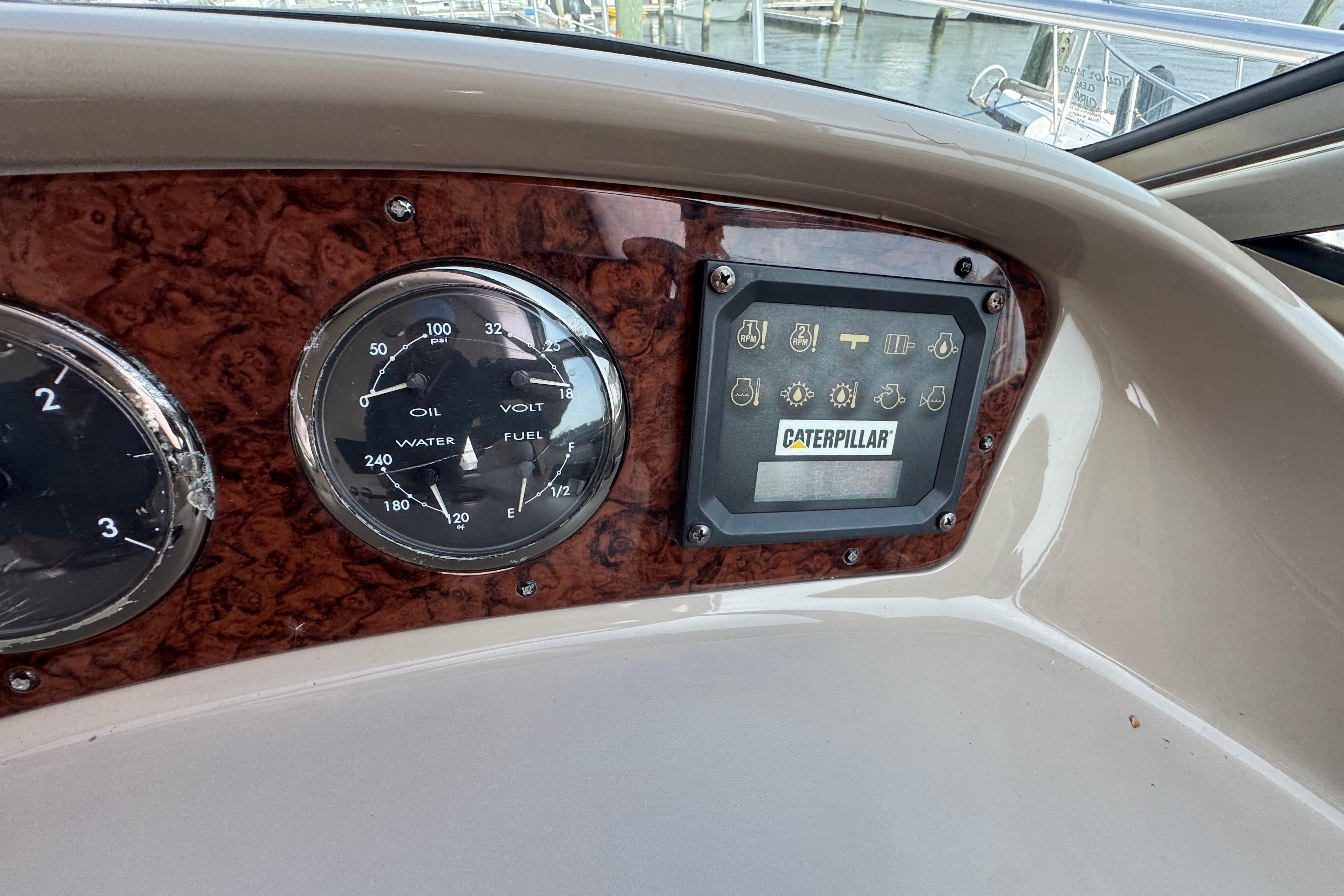 Dashboard of 2001 Sea Ray 510 Sundancer with gauges and Caterpillar display.