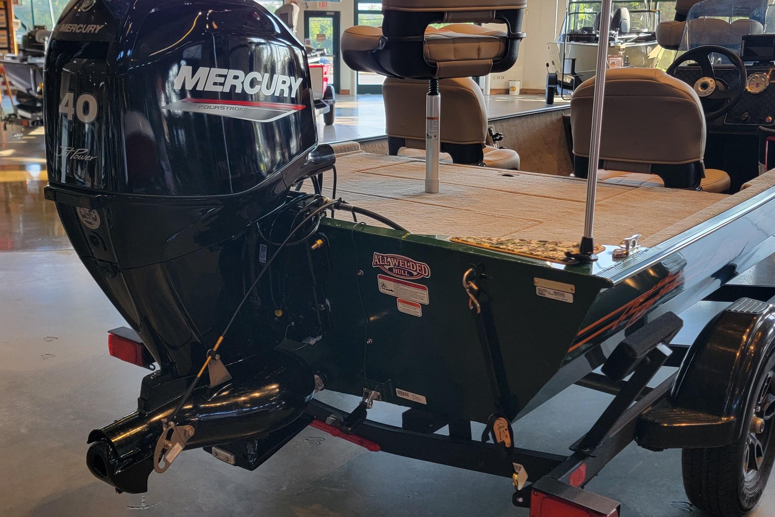 2026 Tracker Bass Tracker Classic Limited boat with Mercury 40HP engine in showroom.